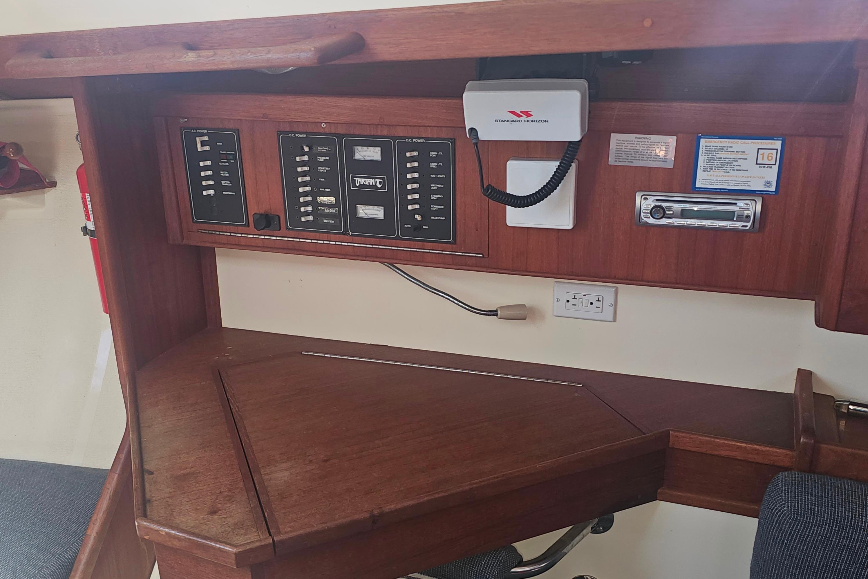 Navigation station of a 1994 Tartan 3100 sailboat with control panels and radio equipment.