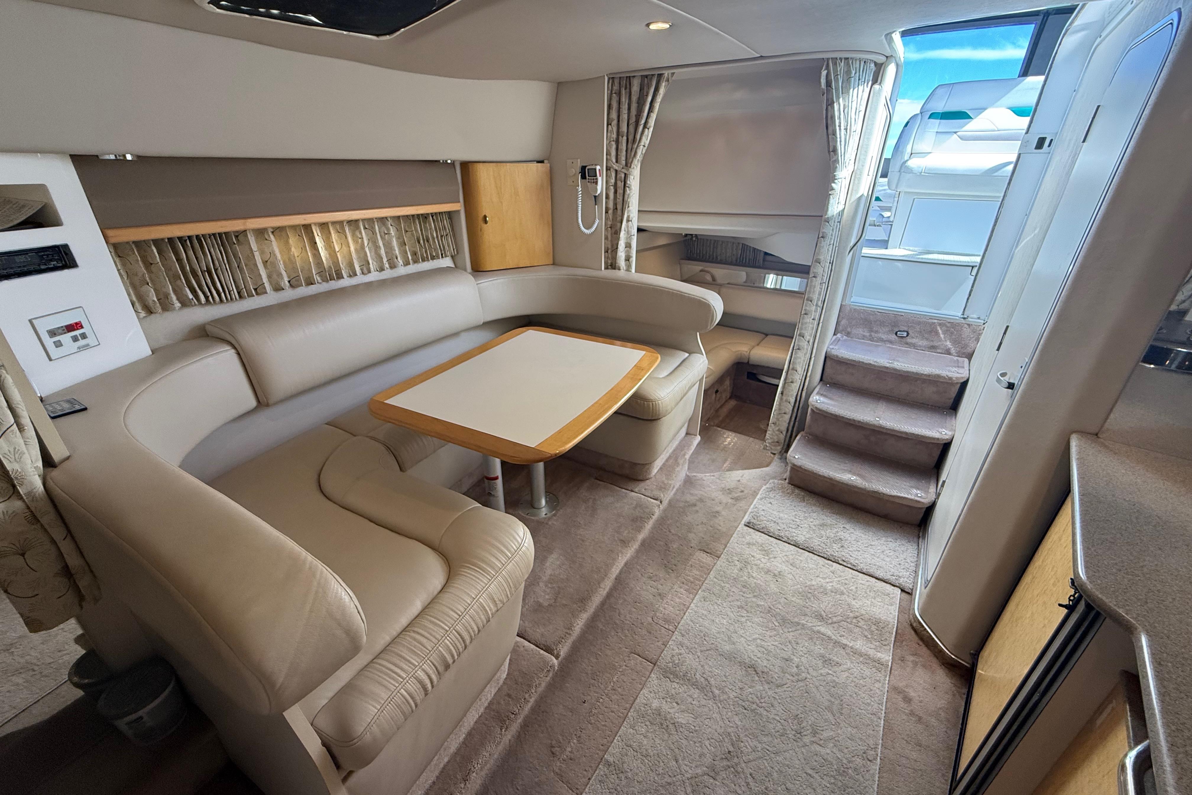 Interior of a 1999 Formula 34 Performance Cruiser with plush seating and dining area.