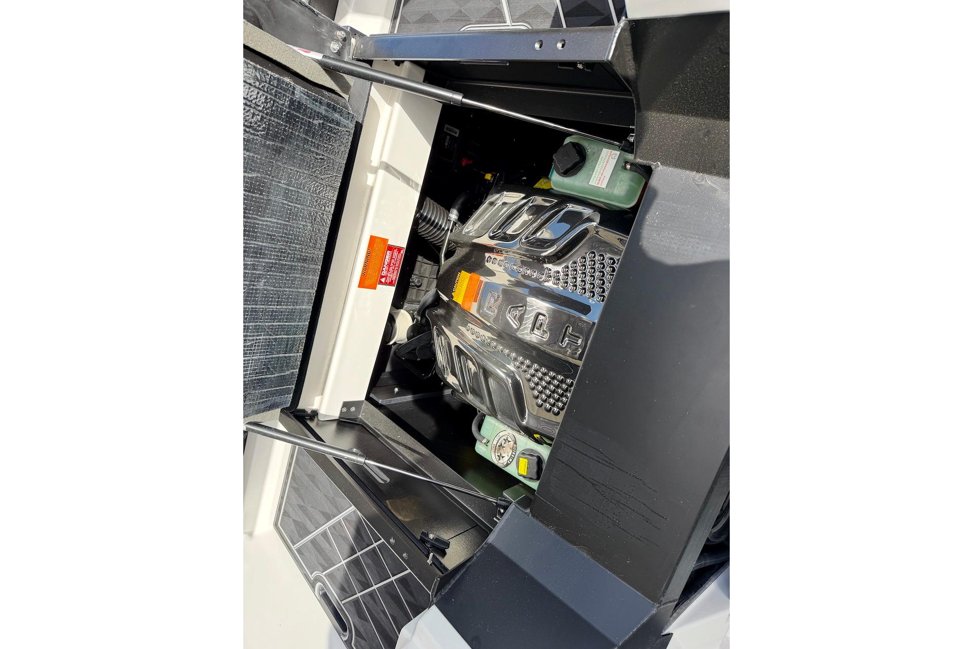 Engine compartment of 2025 Tigé Ultré 25ZX boat, showcasing detailed components and design.