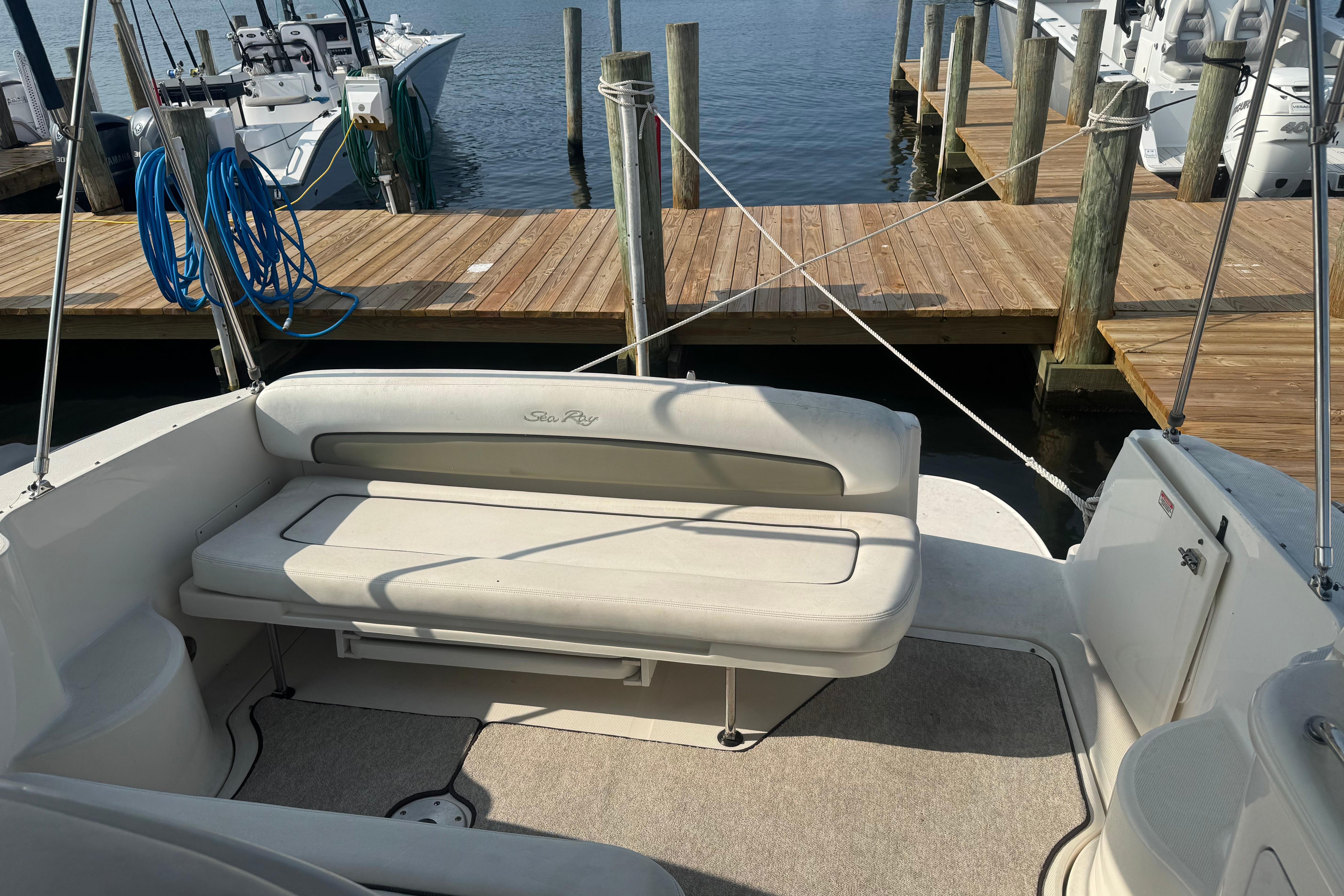 2006 Sea Ray 300 Sundancer boat interior with seating, docked at a marina.