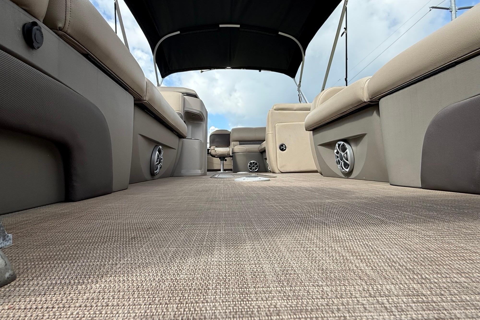 2024 Sun Tracker SportFish 22 XP3 interior with beige seating and canopy.