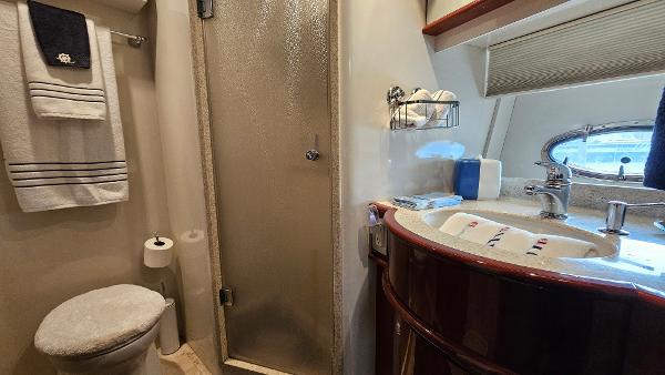 Luxurious bathroom in 2005 Neptunus 56 Flybridge yacht with shower and vanity.