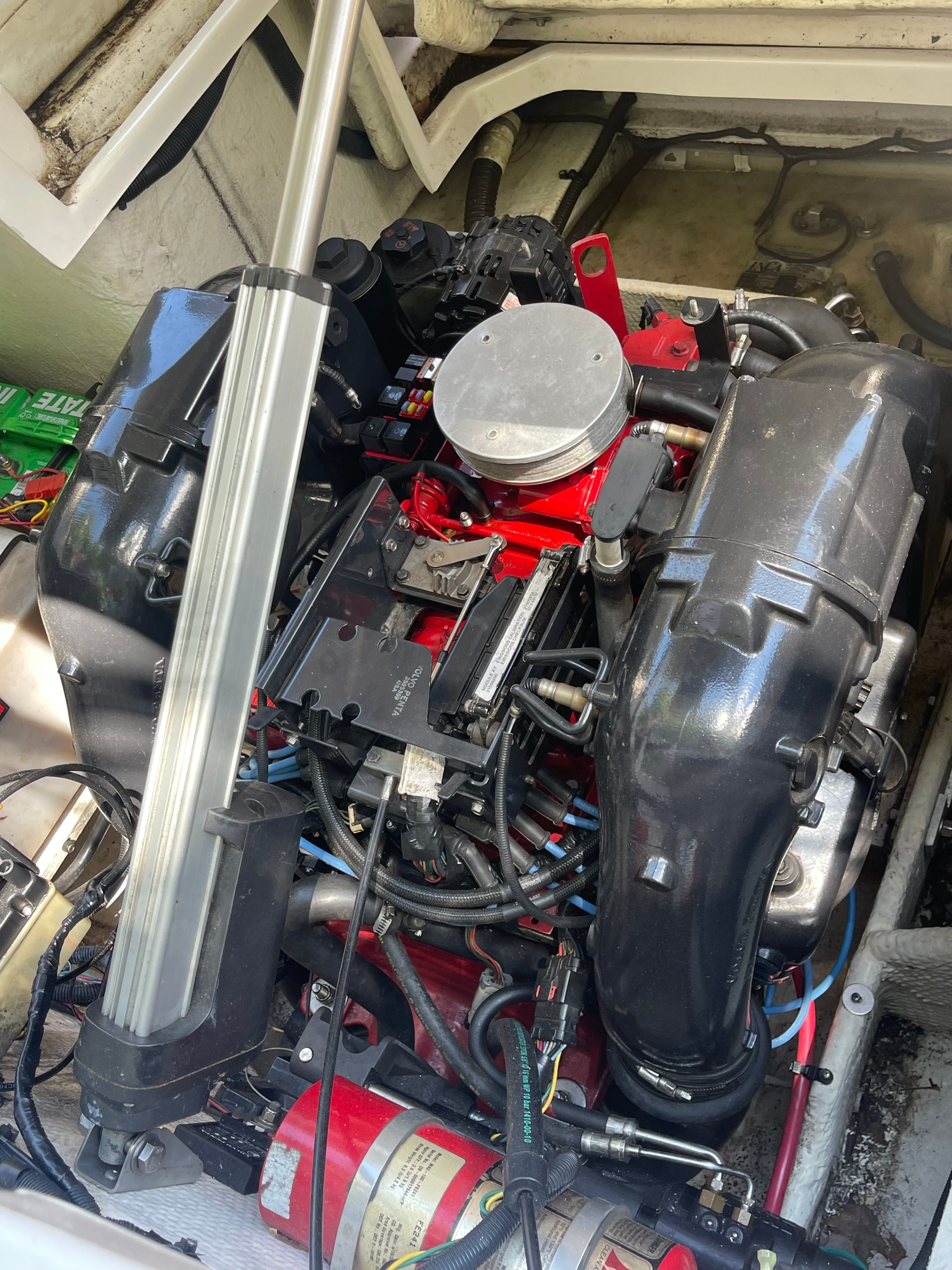An engine compartment with a powerful engine, surrounded by various cables and components.