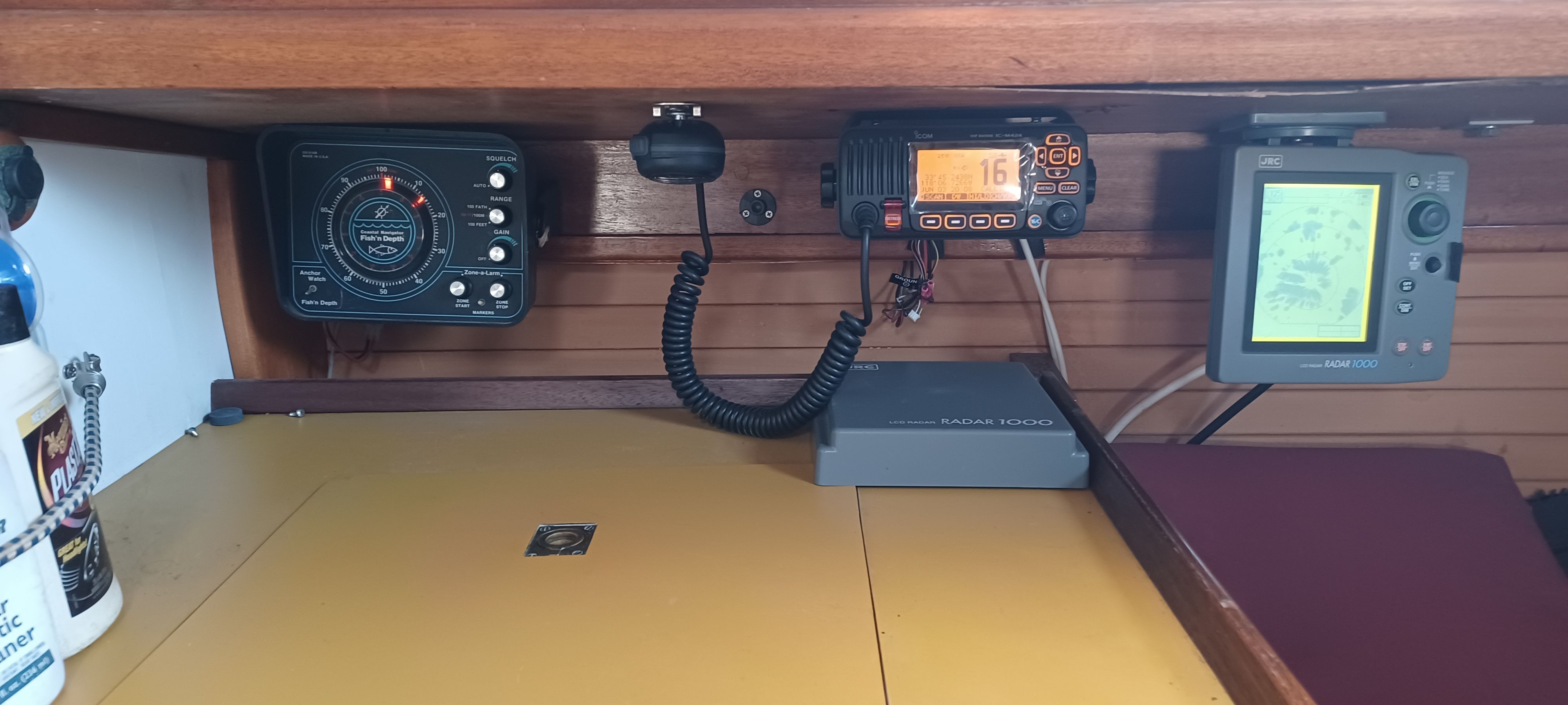 Interior view of a boat with navigation equipment and a radio.
