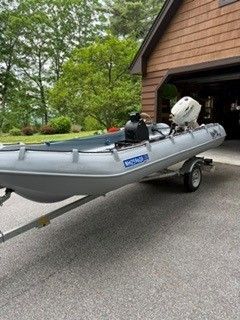 Gray Whaly 435R boat on trailer in front of garage, 2021 model.