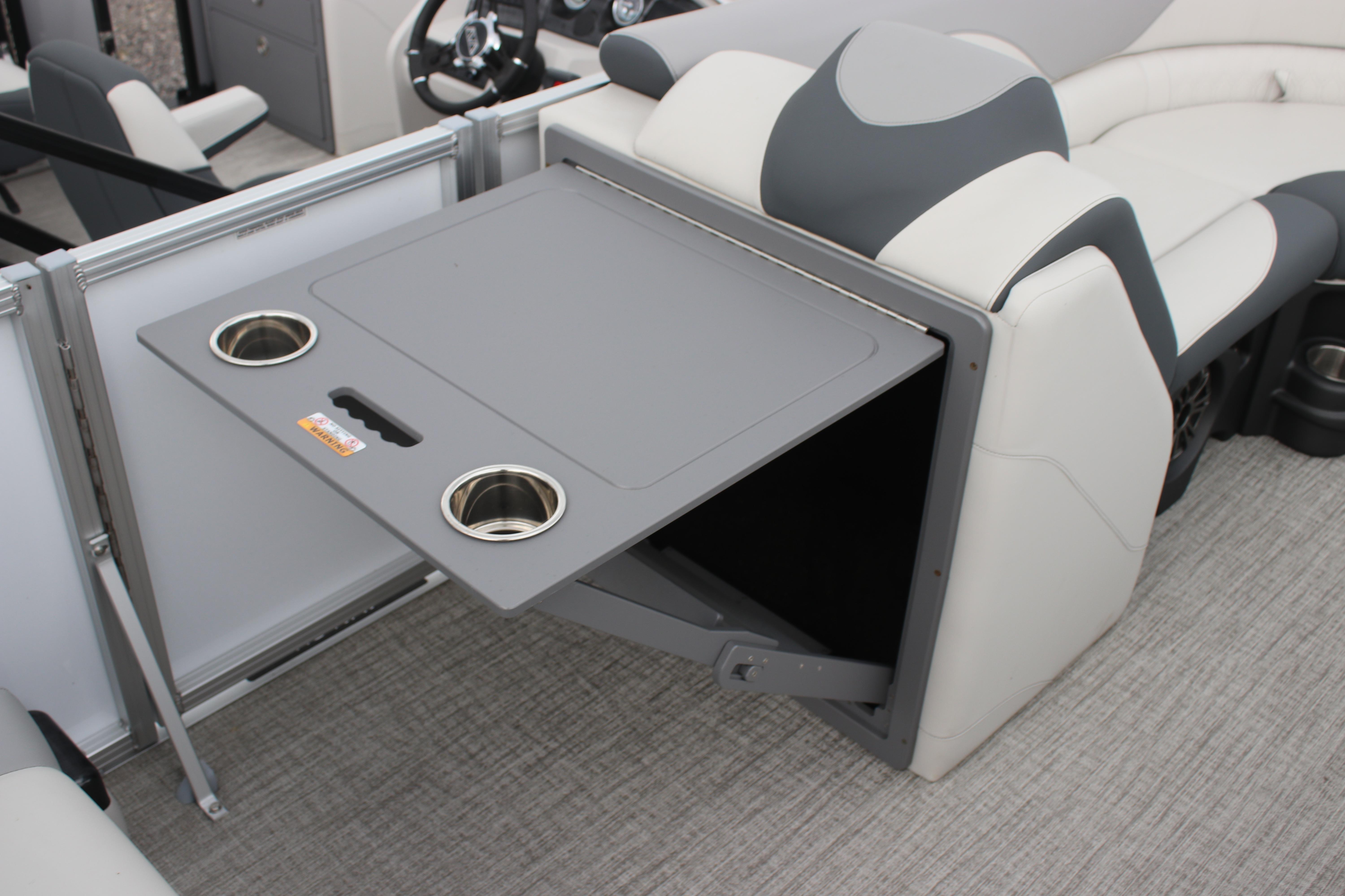2025 Avalon LSZ Quad Lounger with foldable table and cup holders on a boat.