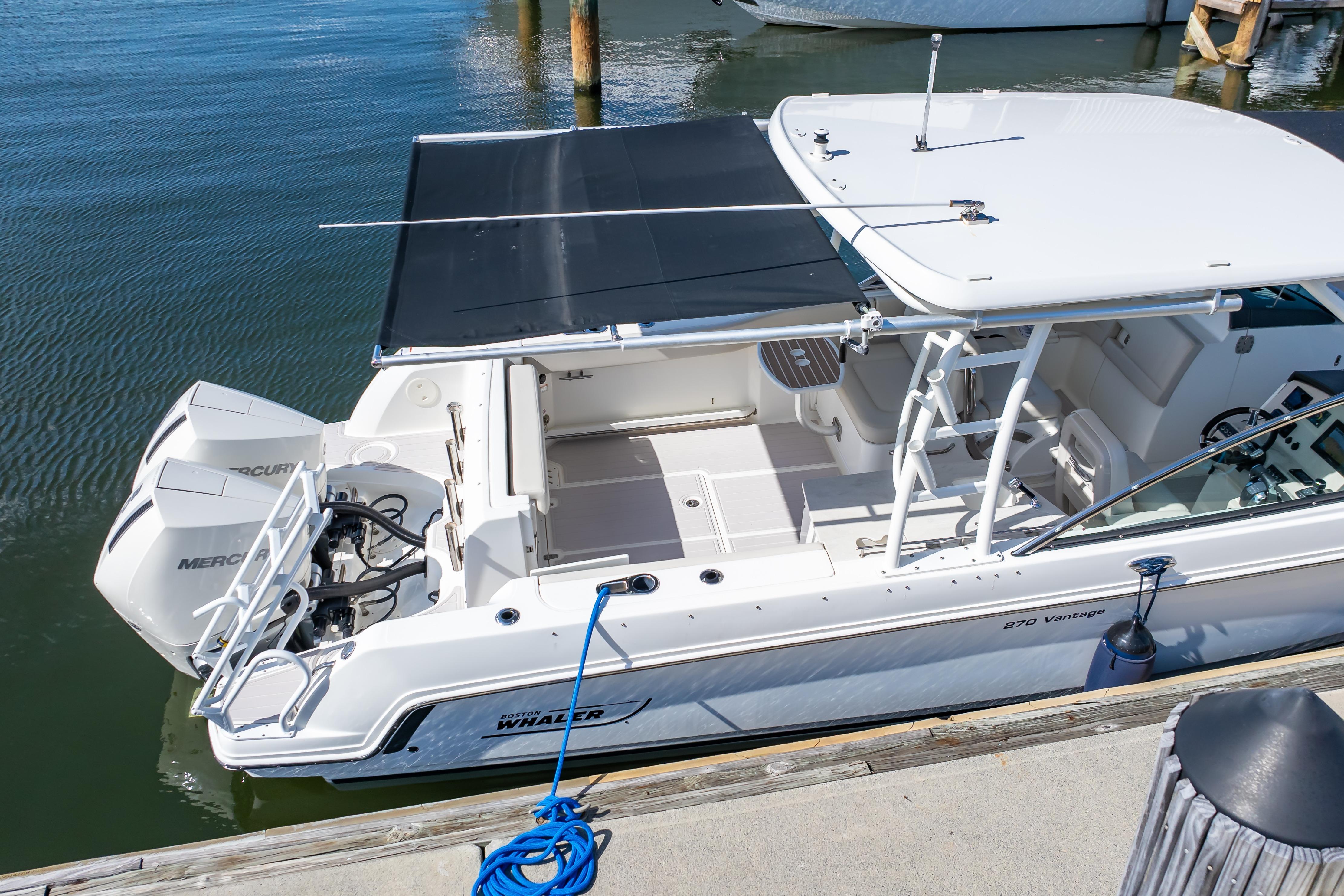 2019 Boston Whaler 270 Vantage boat docked, featuring dual Mercury engines.