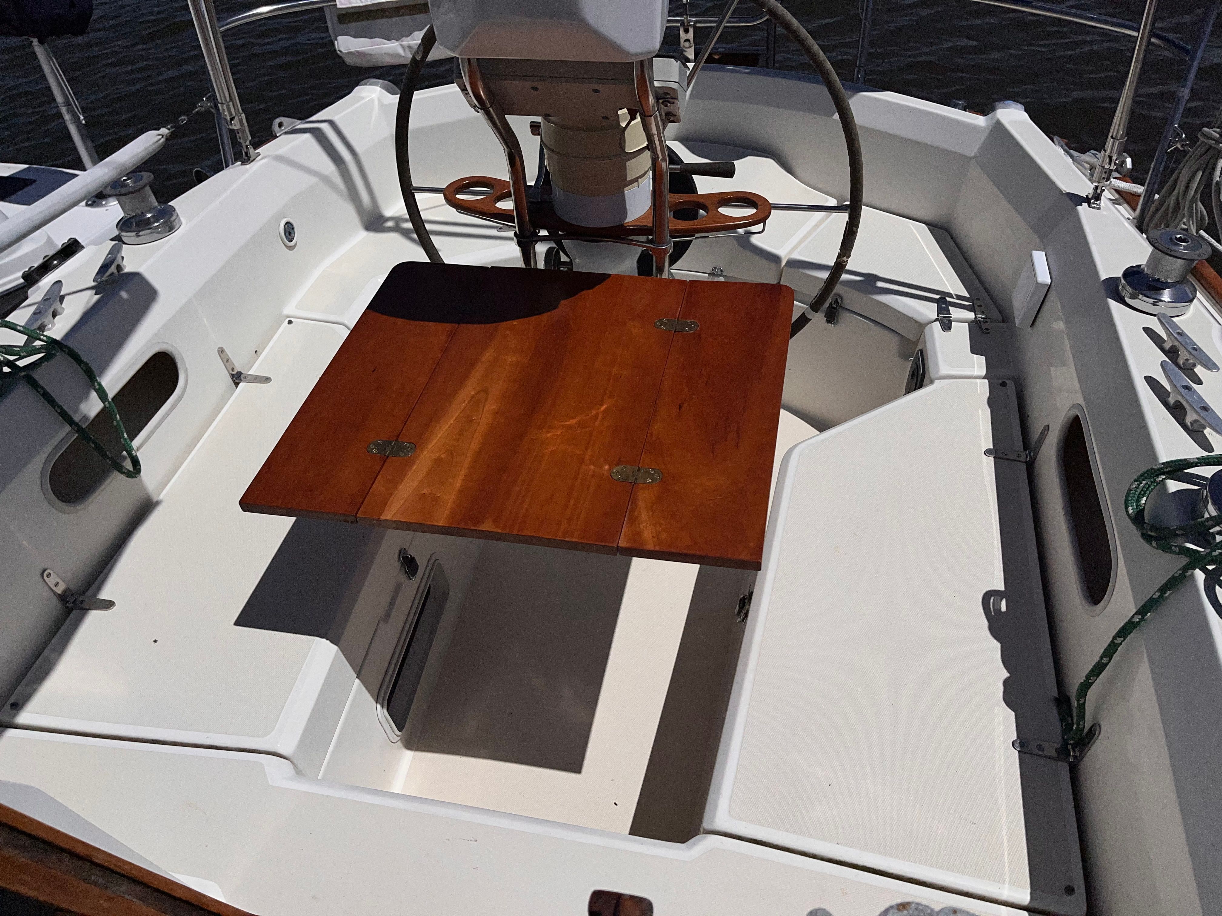 Cockpit of a 1989 Sabre 30 III sailboat with wooden table.