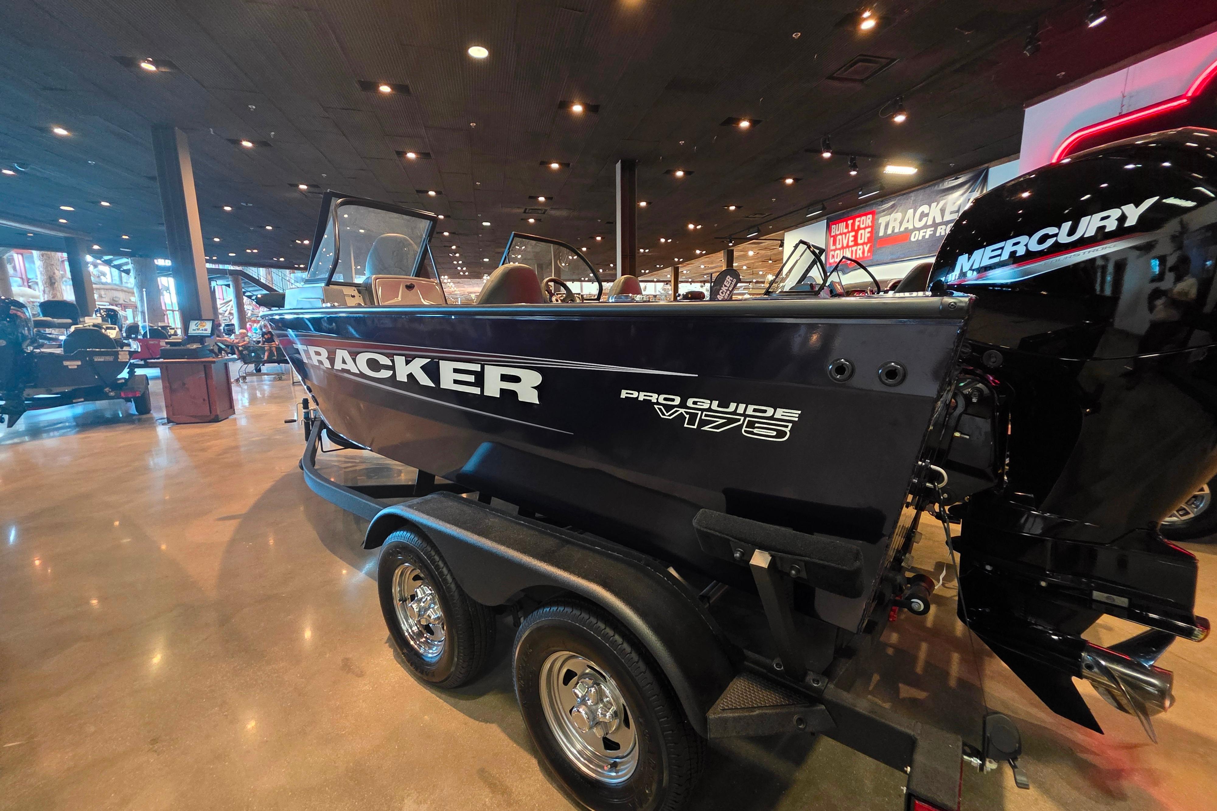 2026 Tracker Pro Guide V-175 Combo boat displayed indoors with Mercury engine.