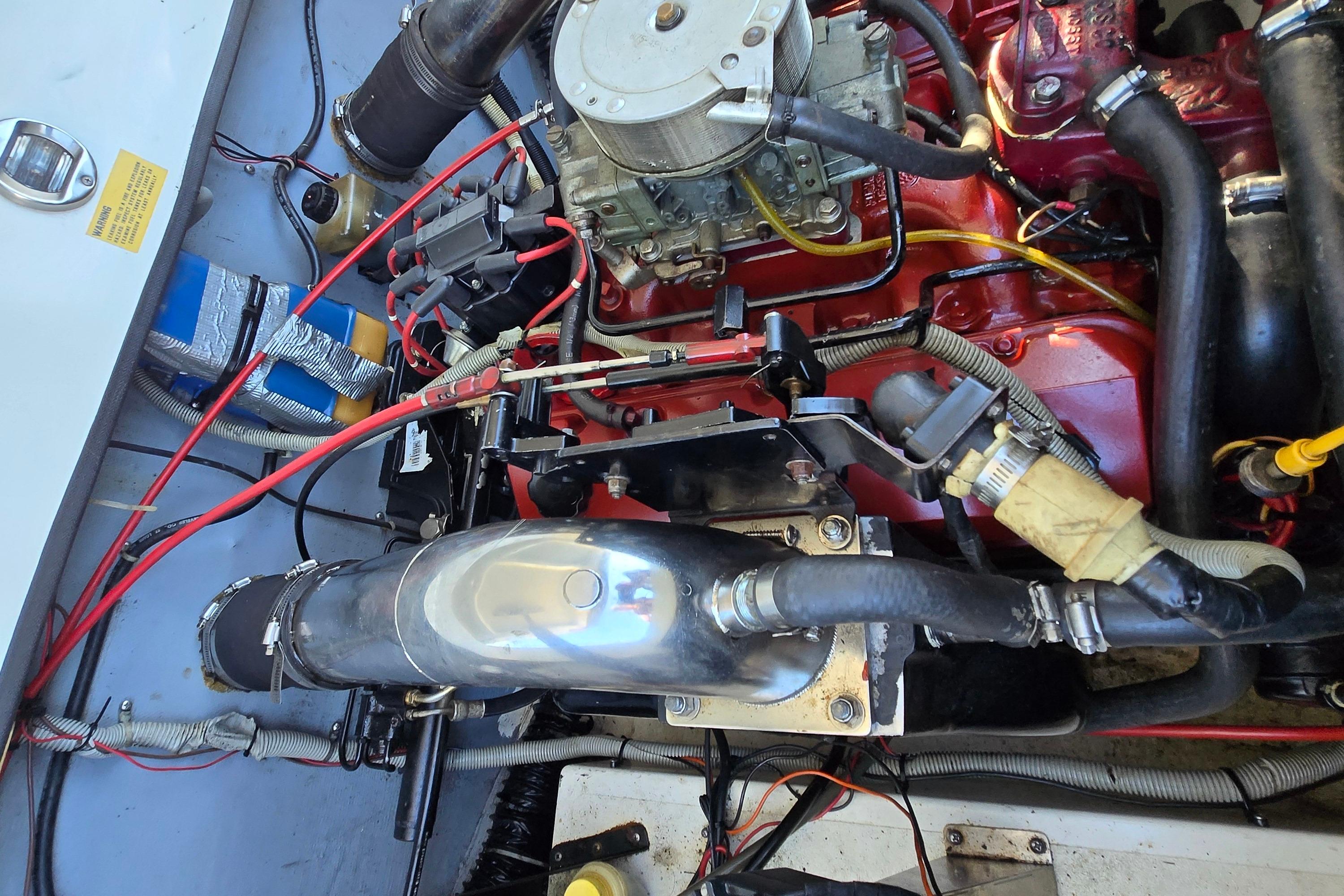Engine compartment of a 1990 Baja 250 ES boat, showcasing detailed mechanical components.