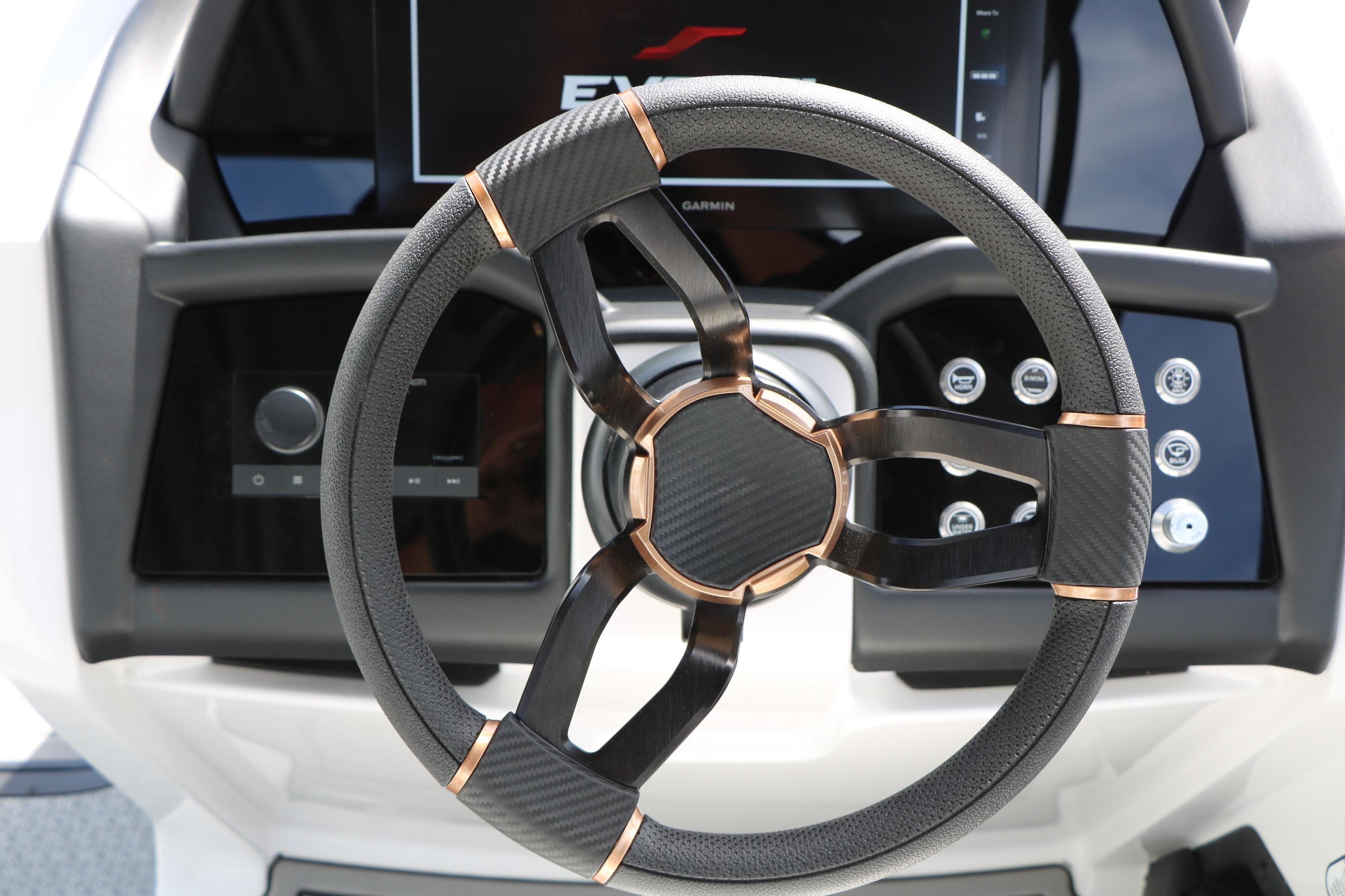 Steering wheel of 2026 Evotti 725 CS Tri-Toon with modern dashboard controls.