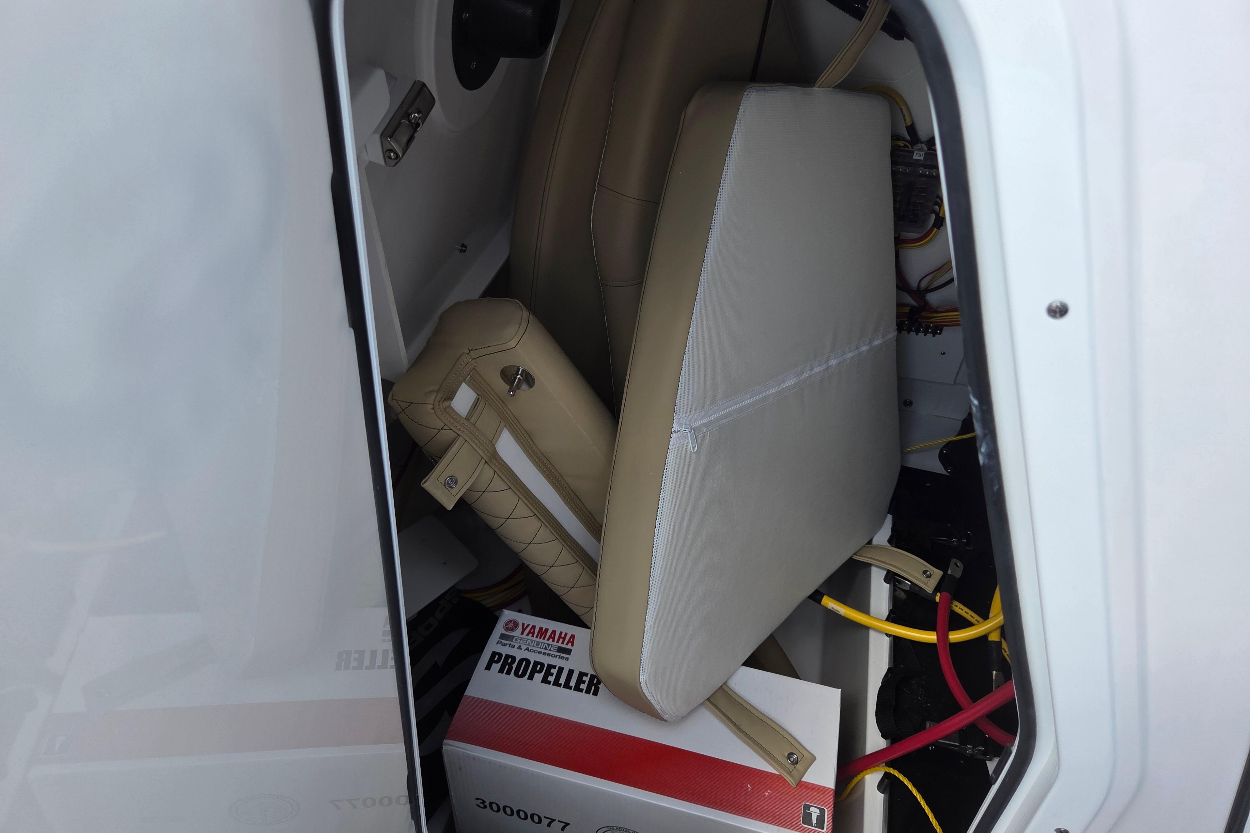 Storage compartment of 2026 Sportsman Open 232 Center Console with Yamaha propeller box.