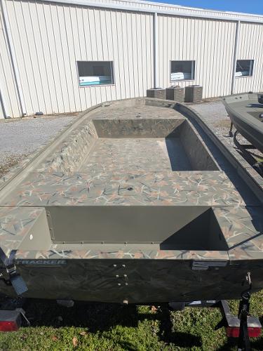 2025 Tracker Grizzly 1754 Jon boat with camouflage design, parked outdoors.