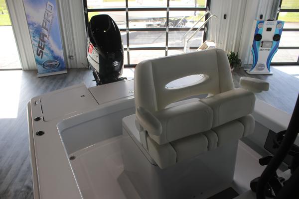 2025 East Cape 25 Open boat interior with seating and motor in showroom.