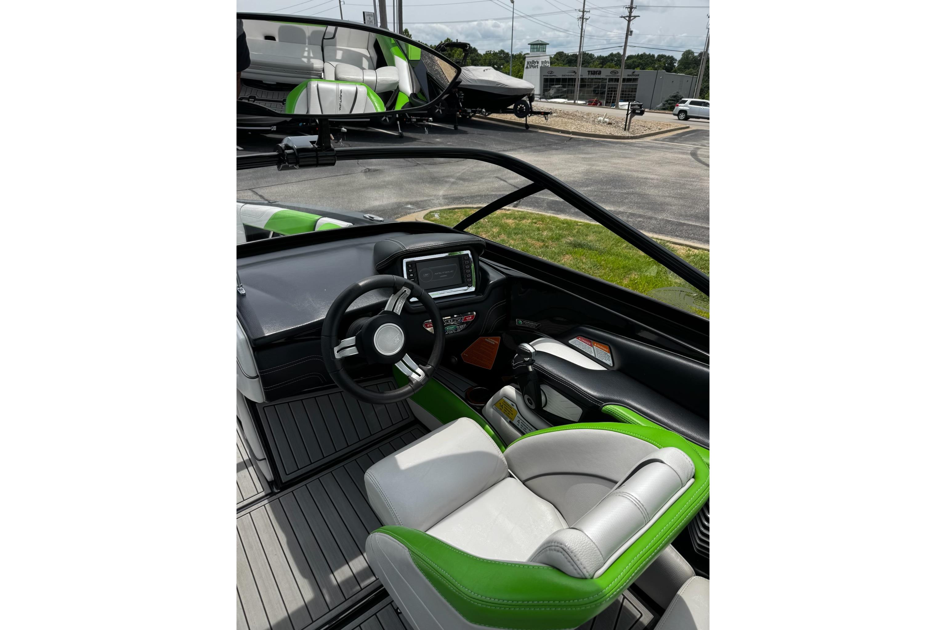 Interior of 2014 Nautique Super Air Nautique G21 boat with green and white seating.