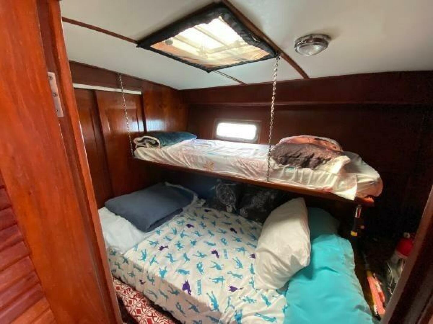 Cozy cabin with bunk beds in 1984 Burns Craft 48 MY boat.