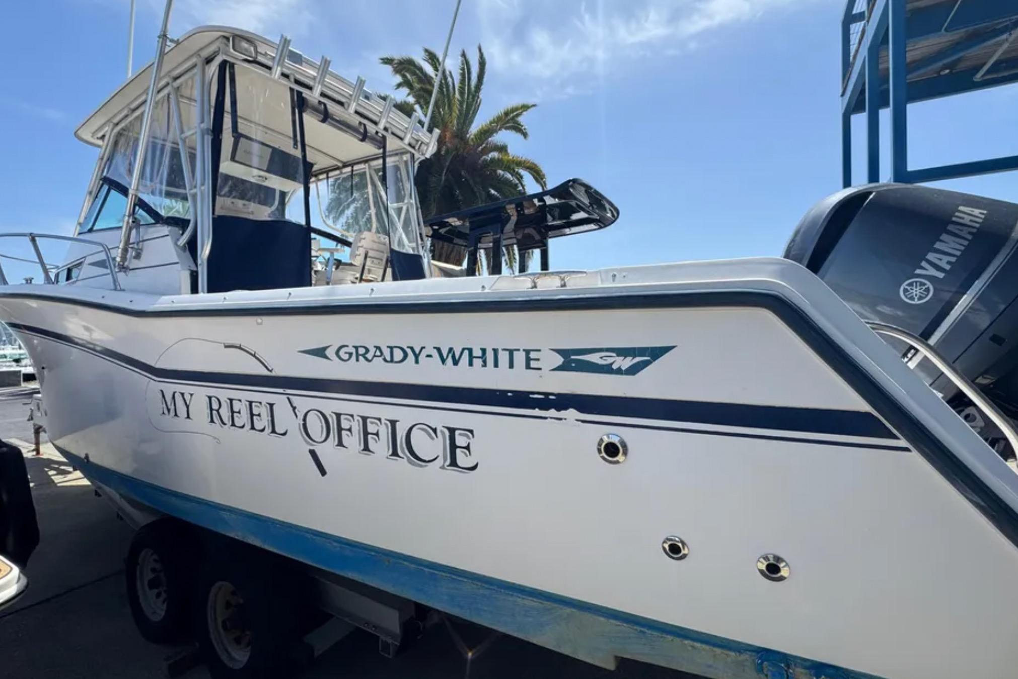 1990 Grady-White Marlin 280 boat named "My Reel Office" on trailer, Yamaha engine visible.