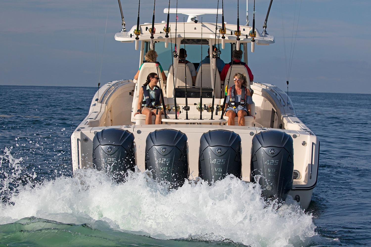 Manufacturer Provided Image: 2023 Grady-White Canyon 456 boat with four outboard engines on the ocean.