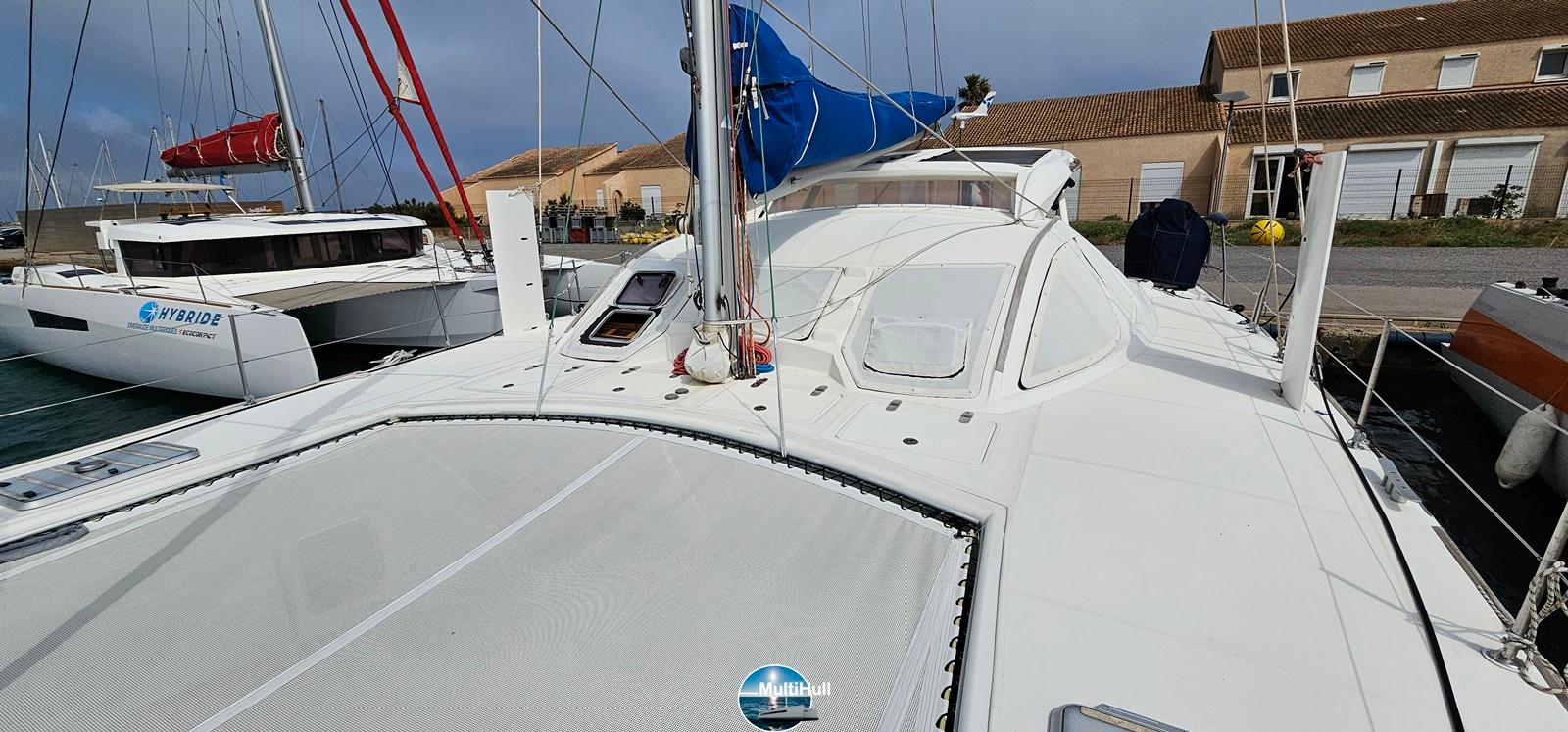 2005 Catana 431 catamaran docked, showcasing sleek design and spacious deck.