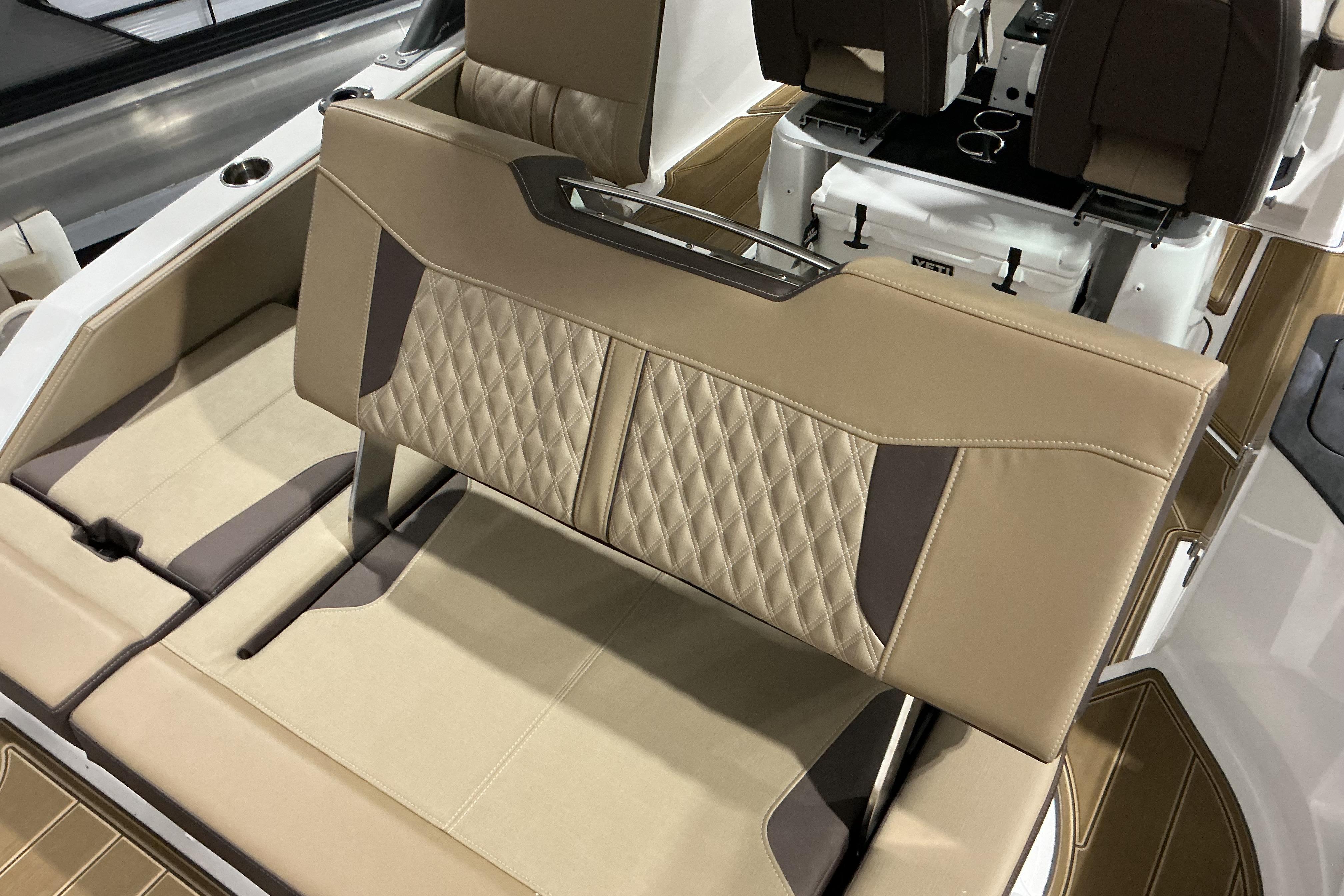 Luxurious seating on 2026 Monterey Elite 25 OB boat with diamond-stitched upholstery.