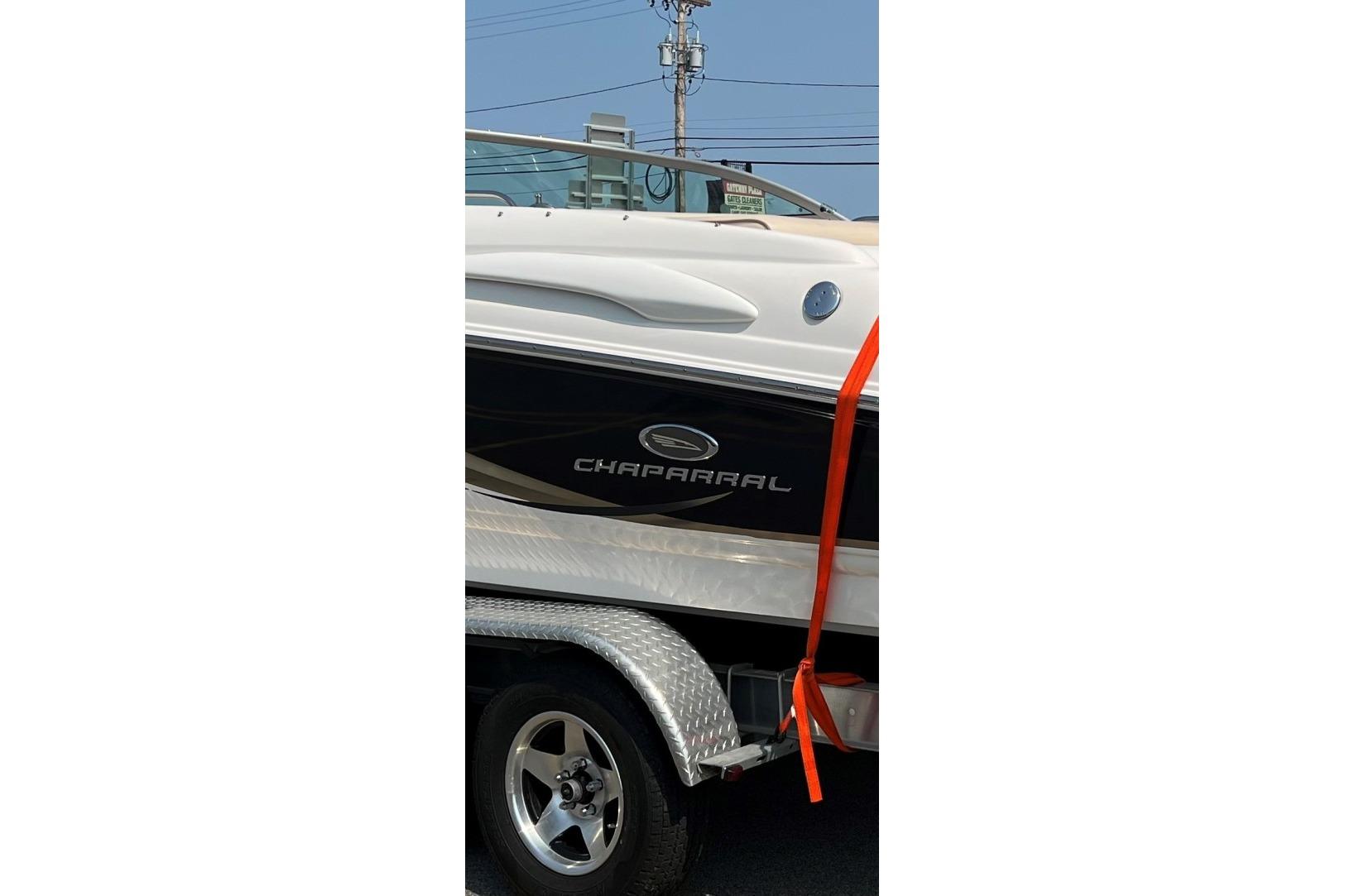 2006 Chaparral 220 SSi boat on trailer with orange strap.