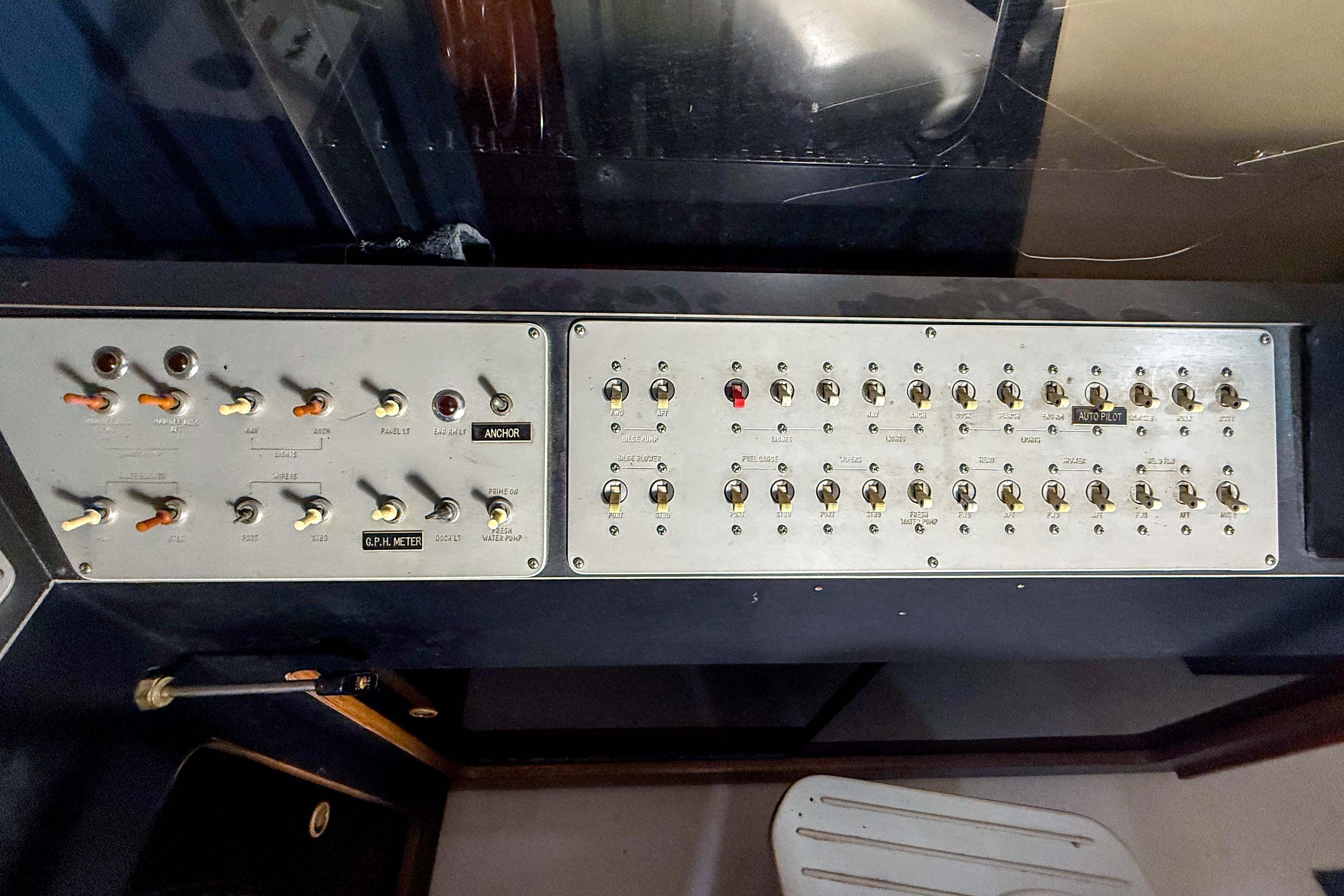 Control panel of a 1977 Pacemaker FB Motor Yacht with various switches and indicators.