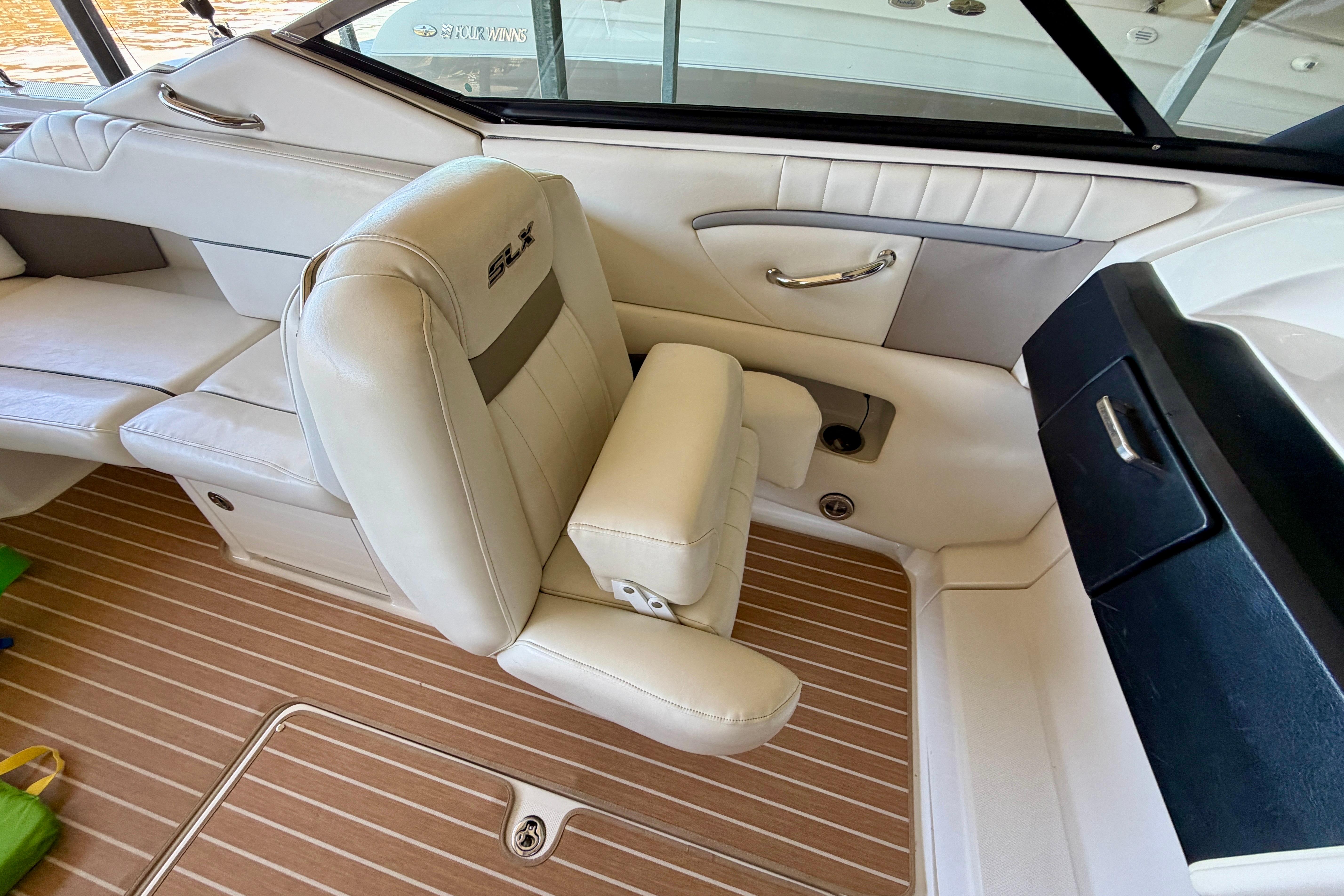 Interior of 2007 Sea Ray 270 SLX boat with beige seating and wood flooring.