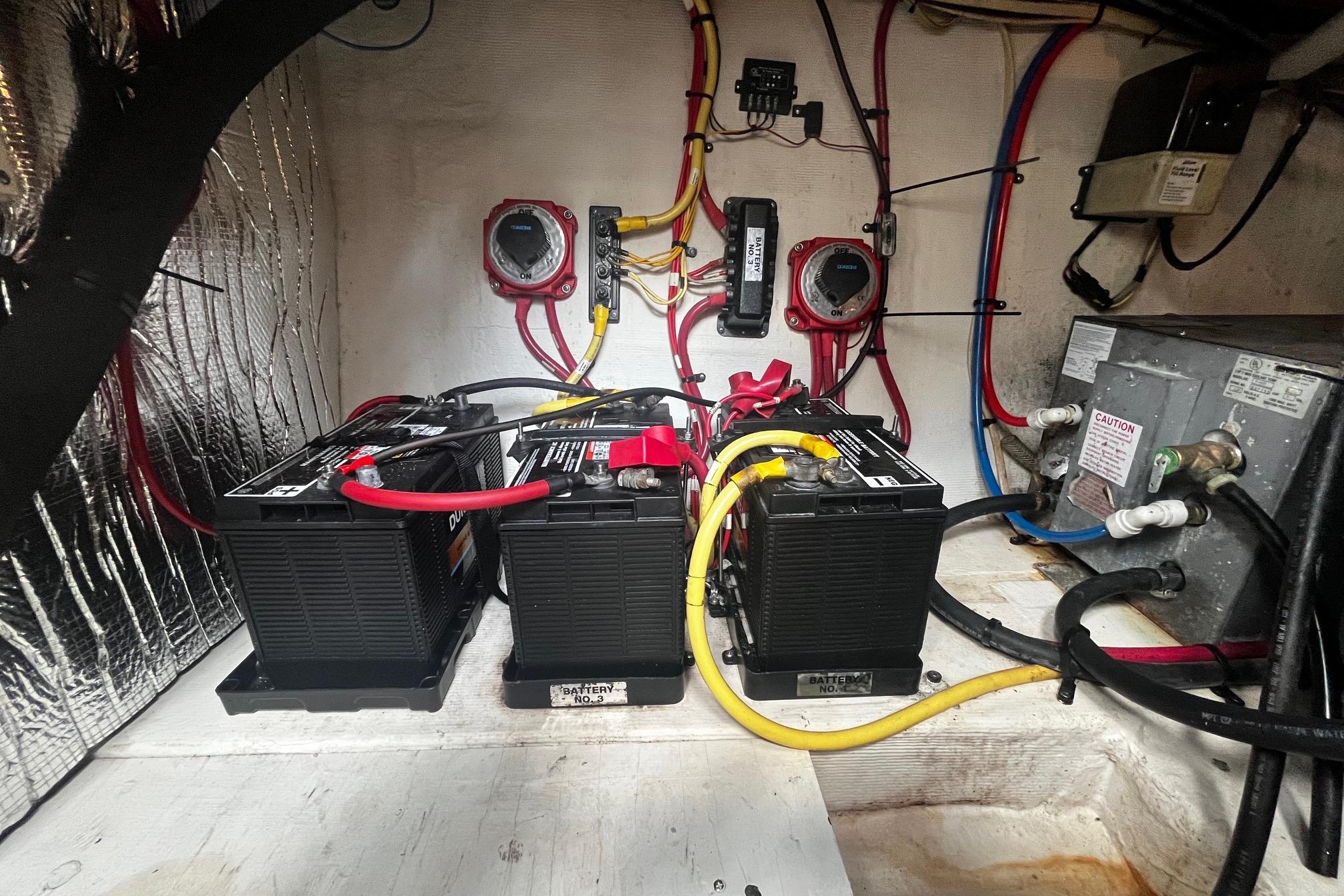 Battery compartment of 2004 Cruisers Yachts 280 CXi Express with wiring and connections.