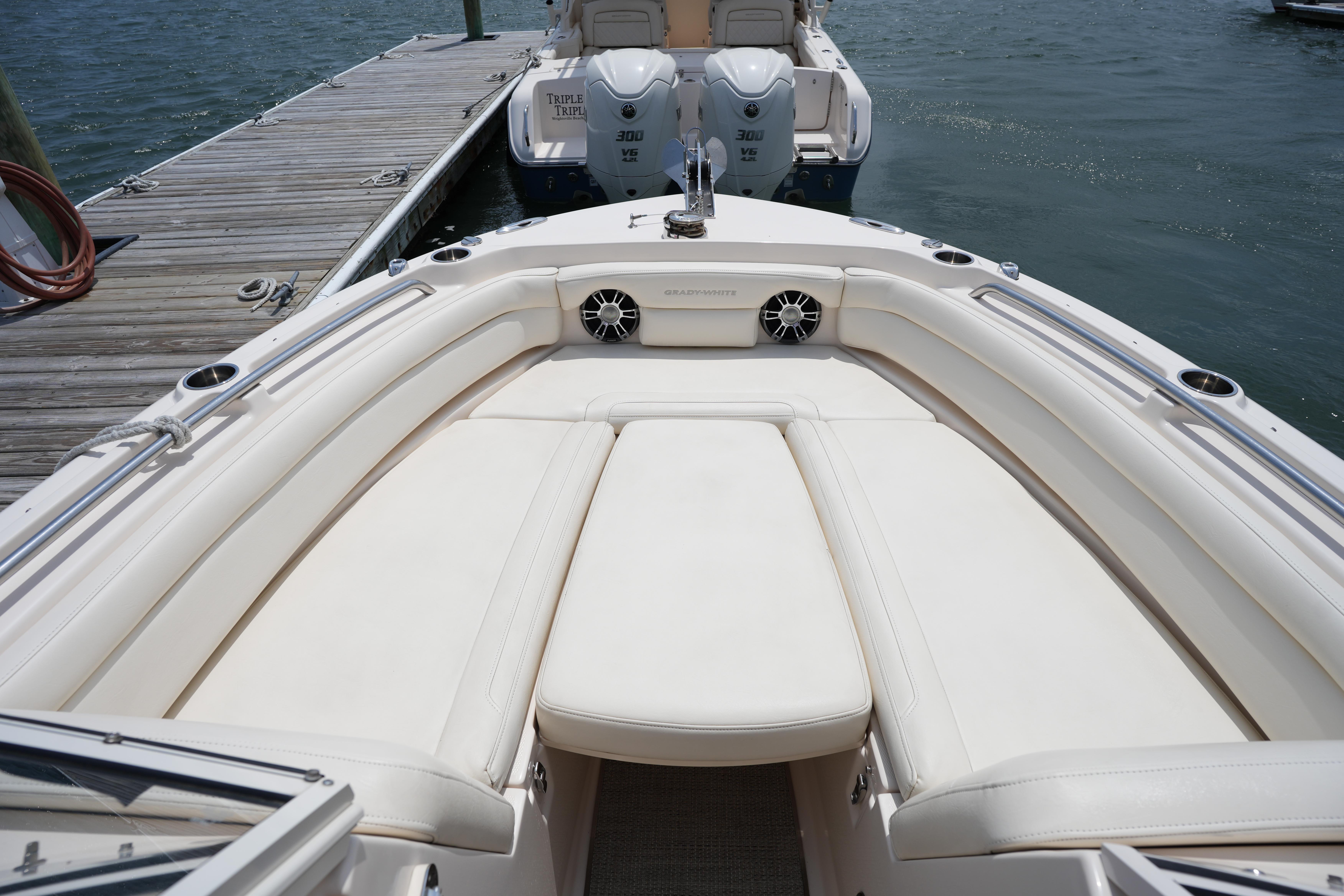 2021 Grady-White Freedom 235 boat with spacious seating, docked by the water.