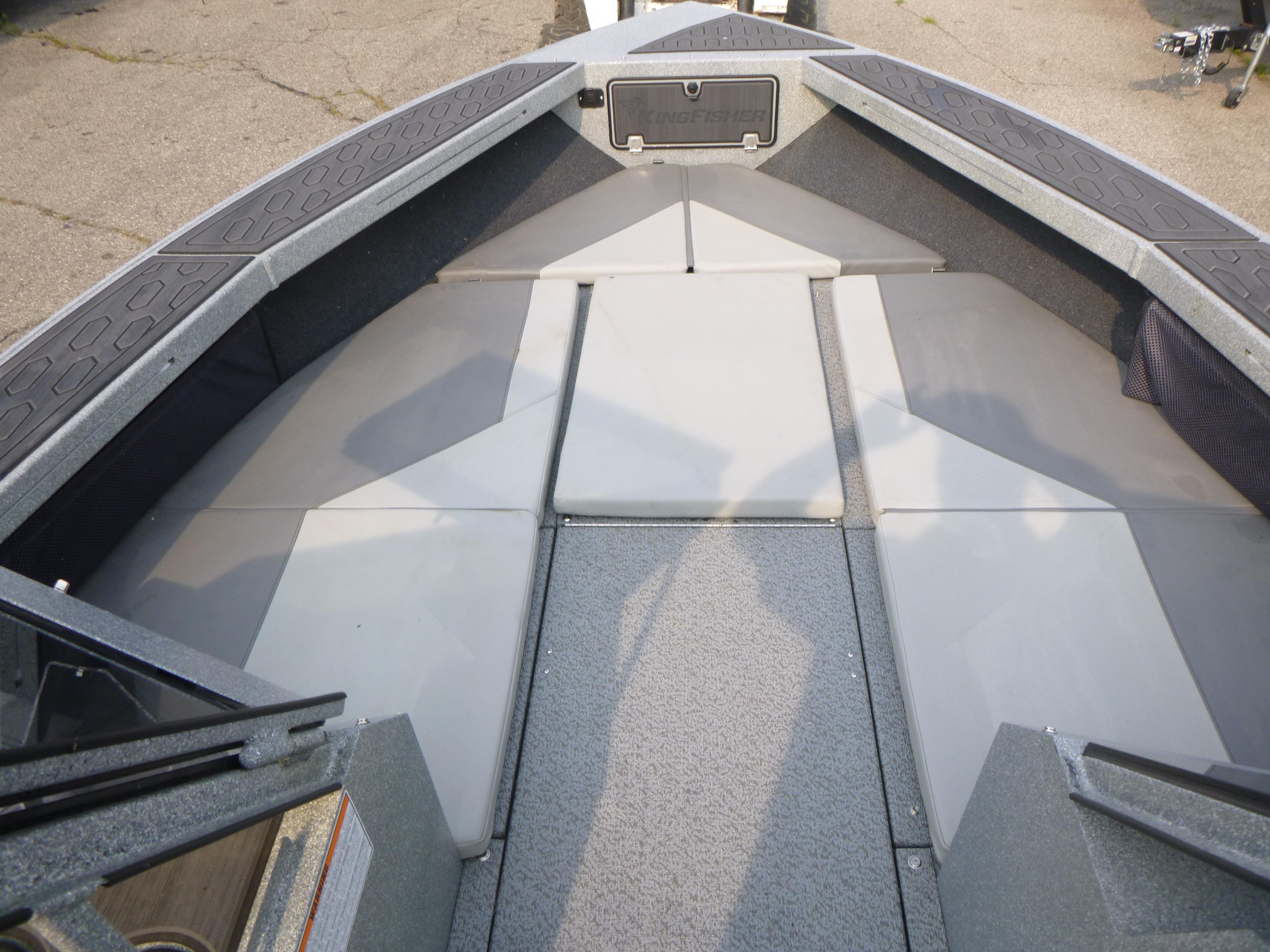 2025 KingFisher 2125 Arrow Sport boat interior with cushioned seating and storage.