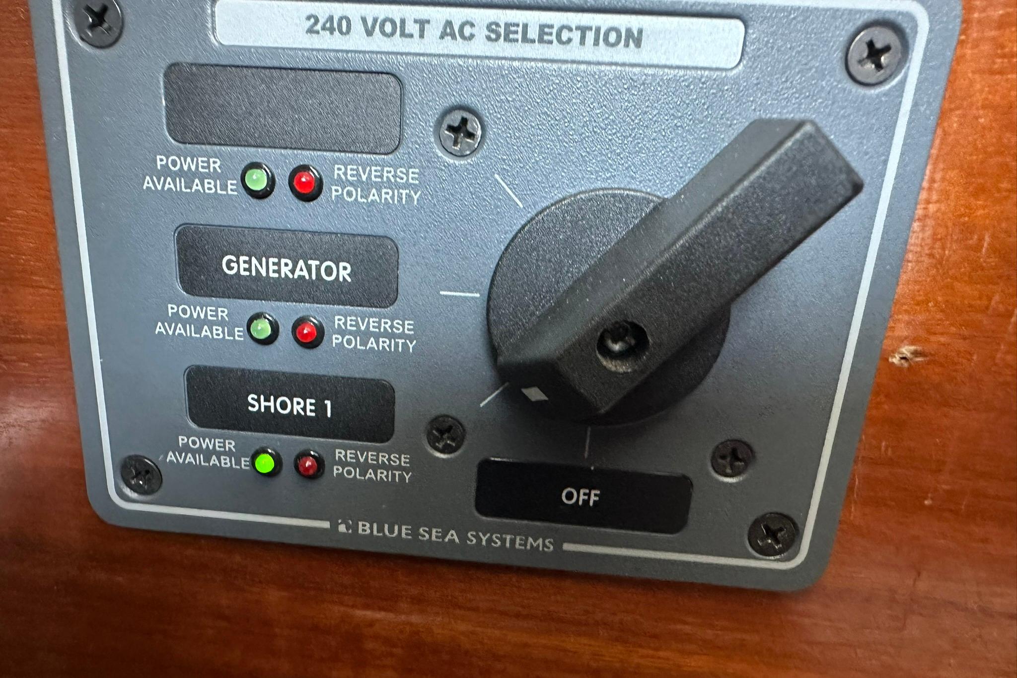 Control panel on a 2000 Beneteau 50 yacht, featuring 240V AC selection.