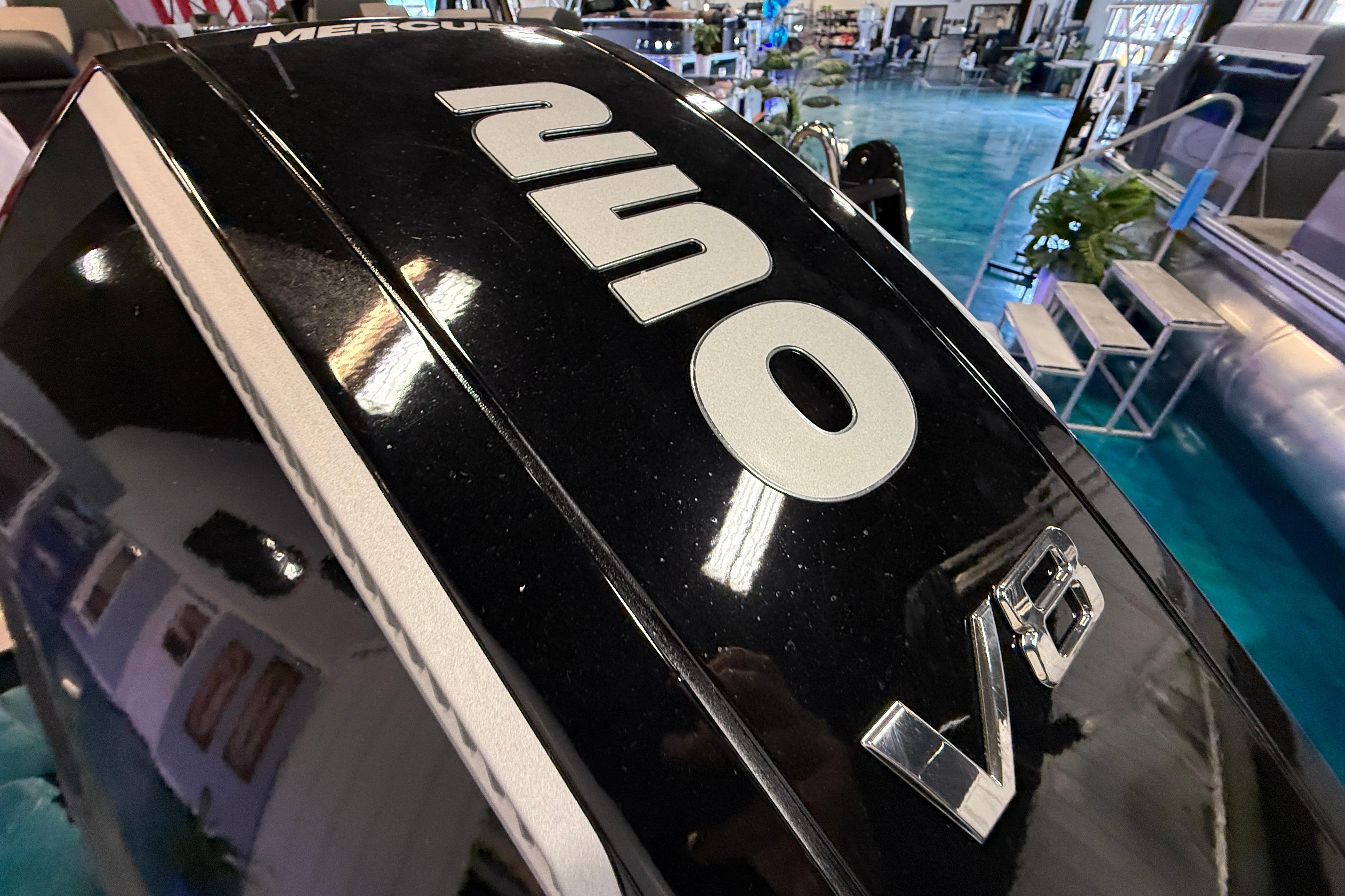 Close-up of a 2026 Tahoe Pontoon Cascade Cruise Rear Bench engine, featuring "250" and "V8" labels.
