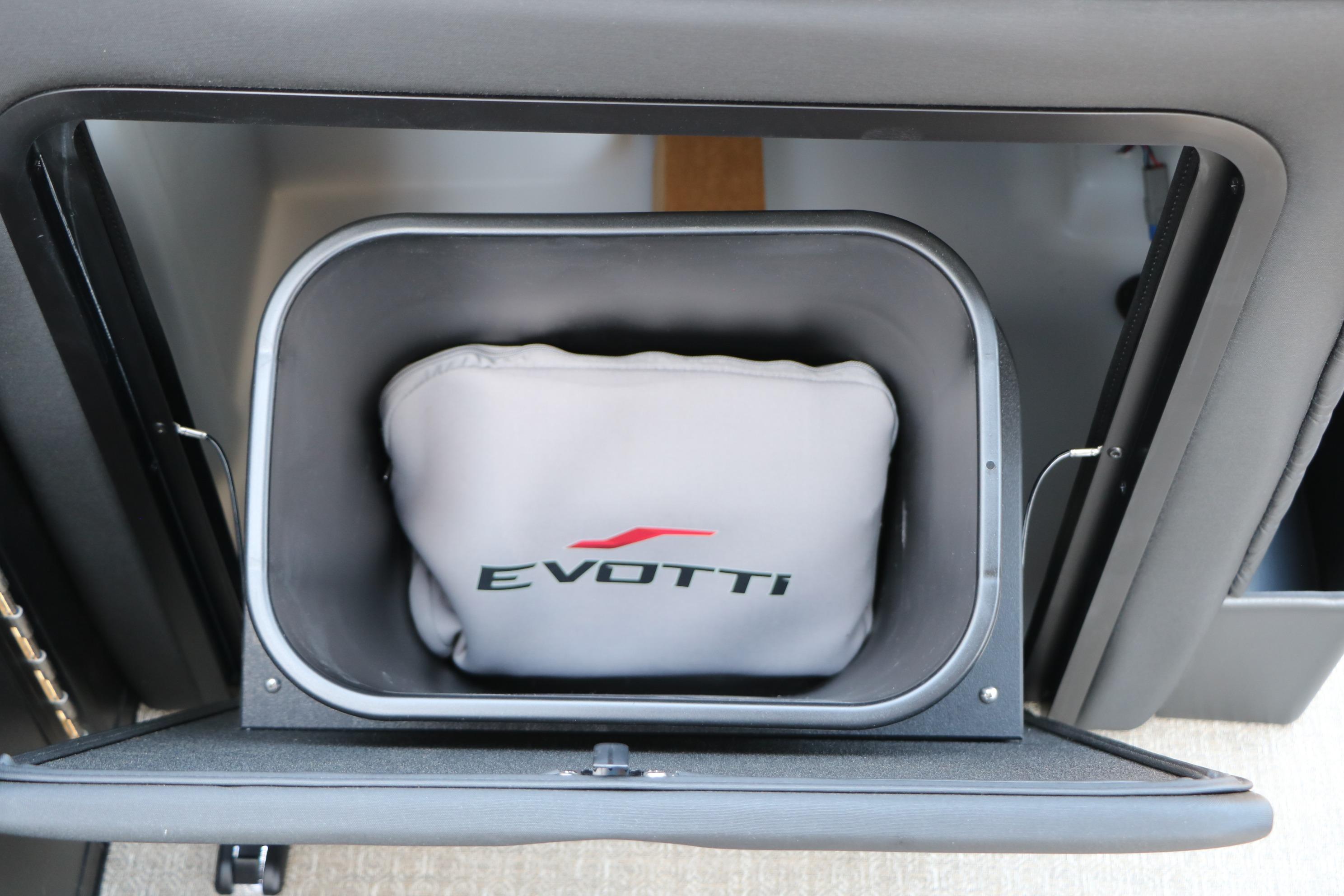 Storage compartment of 2026 Evotti 725 CS Tri-Toon with branded cushion inside.