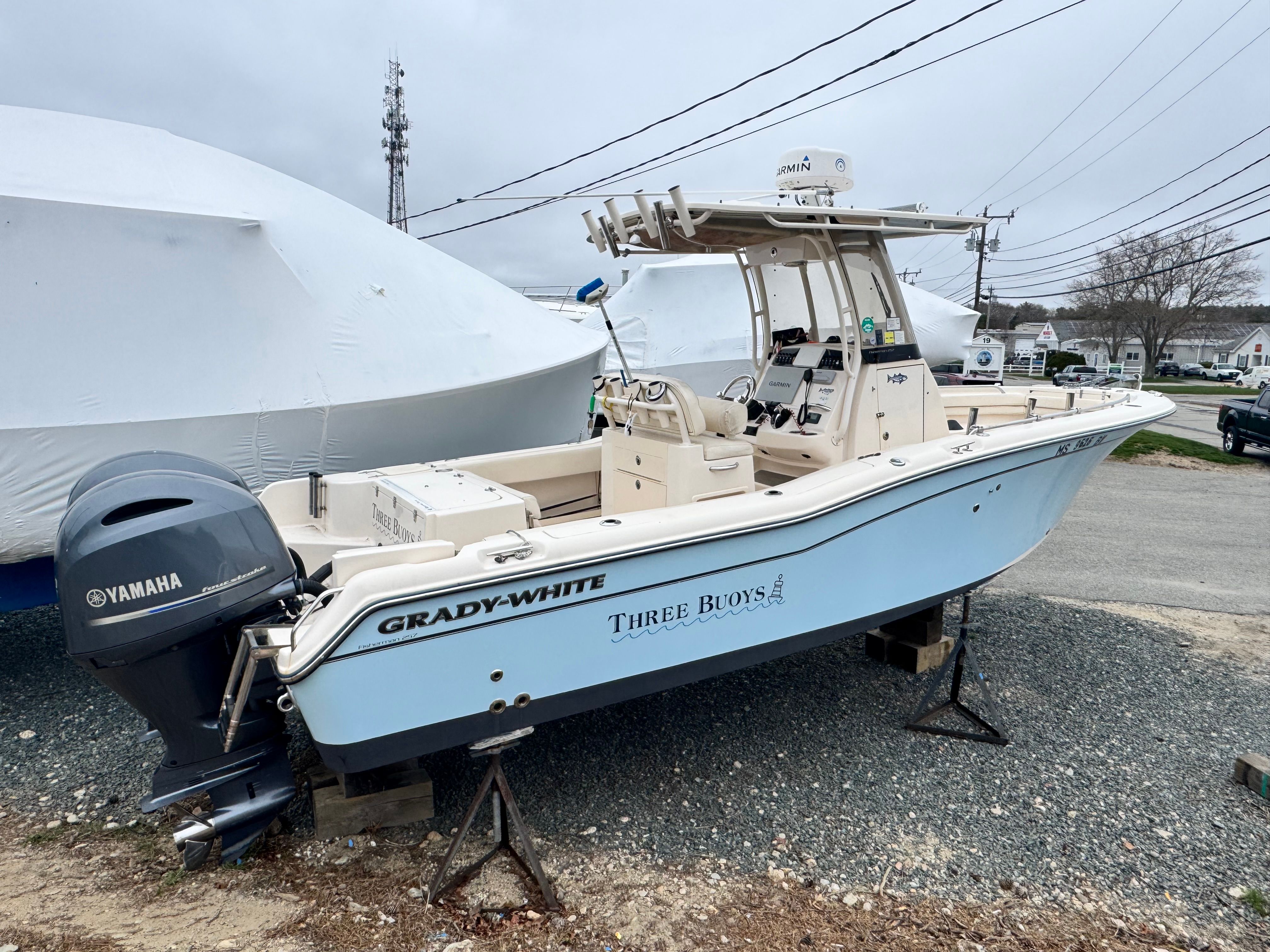 Grady-White Fisherman 257 boat, 2021 model, with Yamaha engine, parked outdoors.