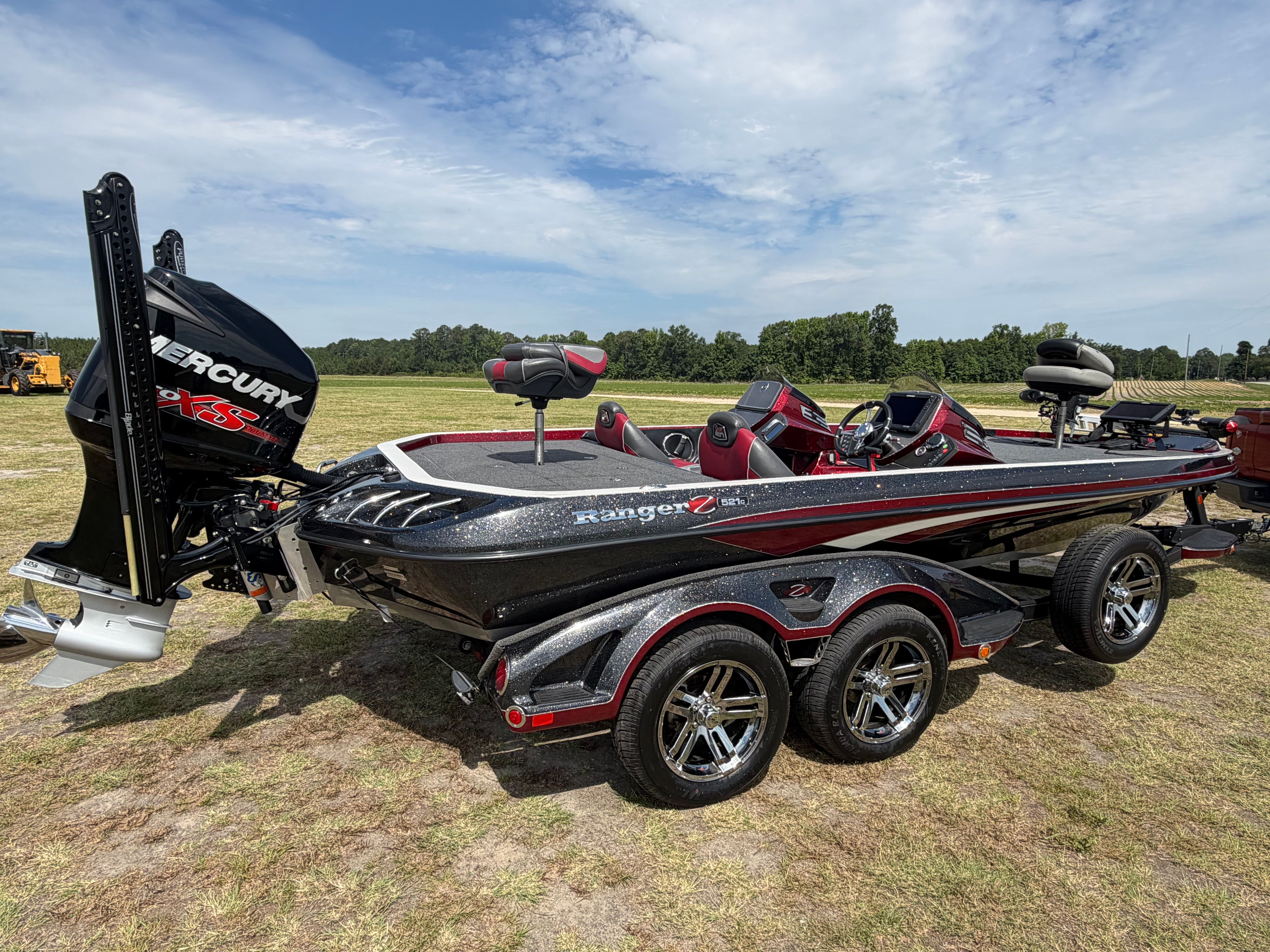 A Ranger 521C boat is on a trailer in a field.