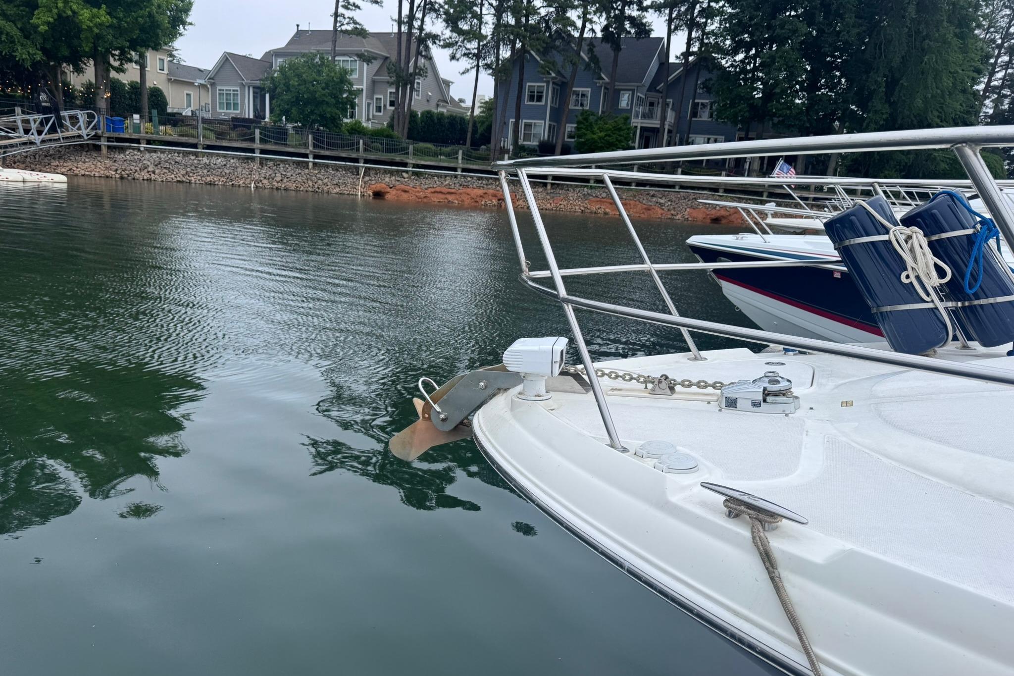 2004 Sea Ray 390 Sundancer docked on calm water near residential area.