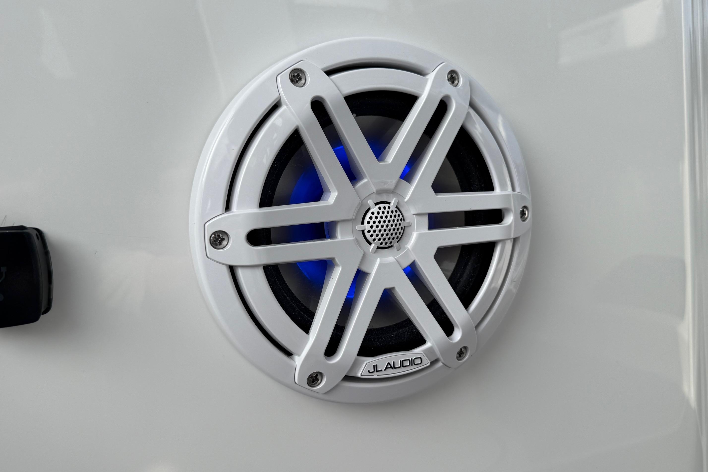 White JL Audio speaker with blue lighting on a 2026 Monterey Elite 25 OB boat.