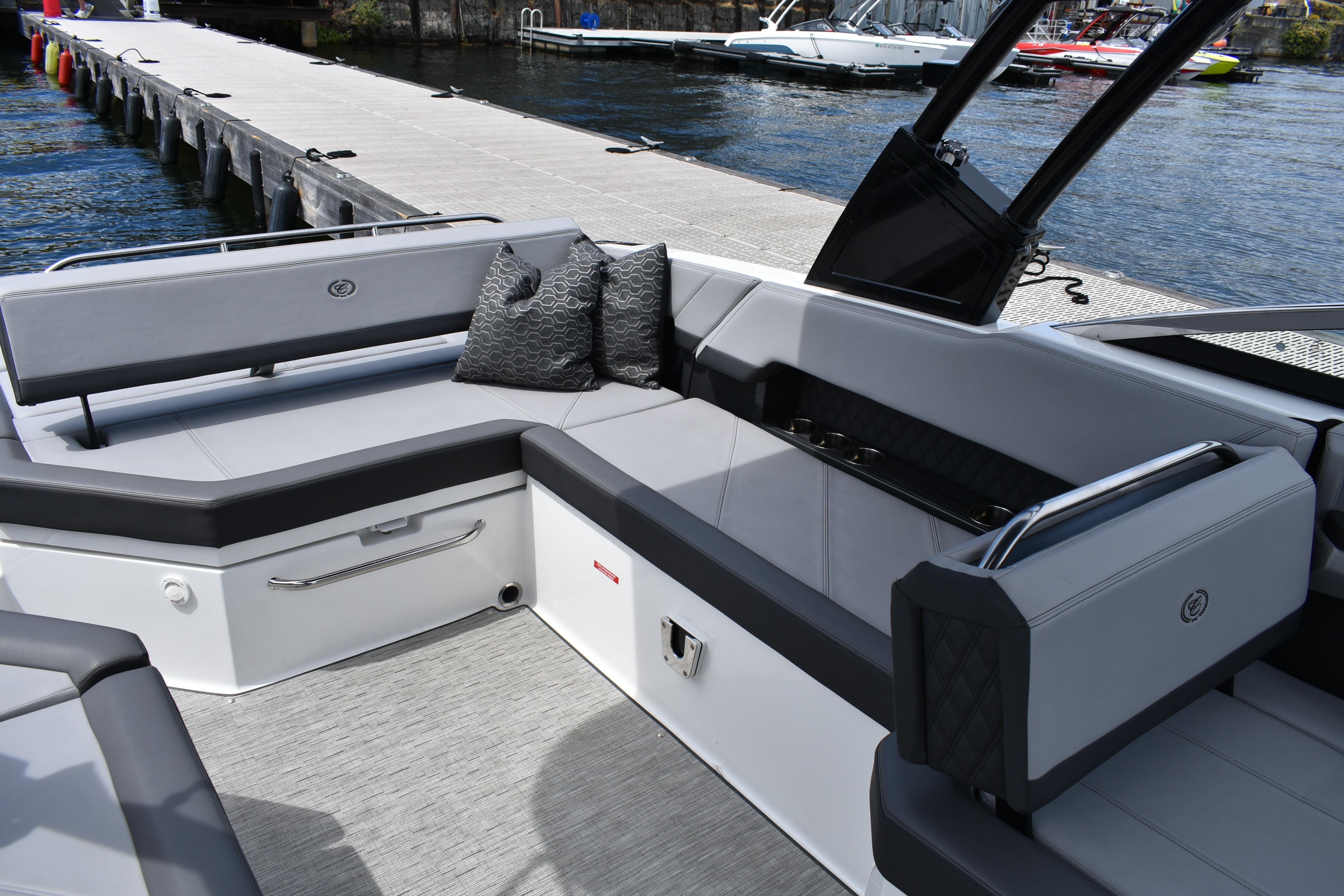 Luxurious seating area on a 2023 Cobalt R8 boat docked by the water.