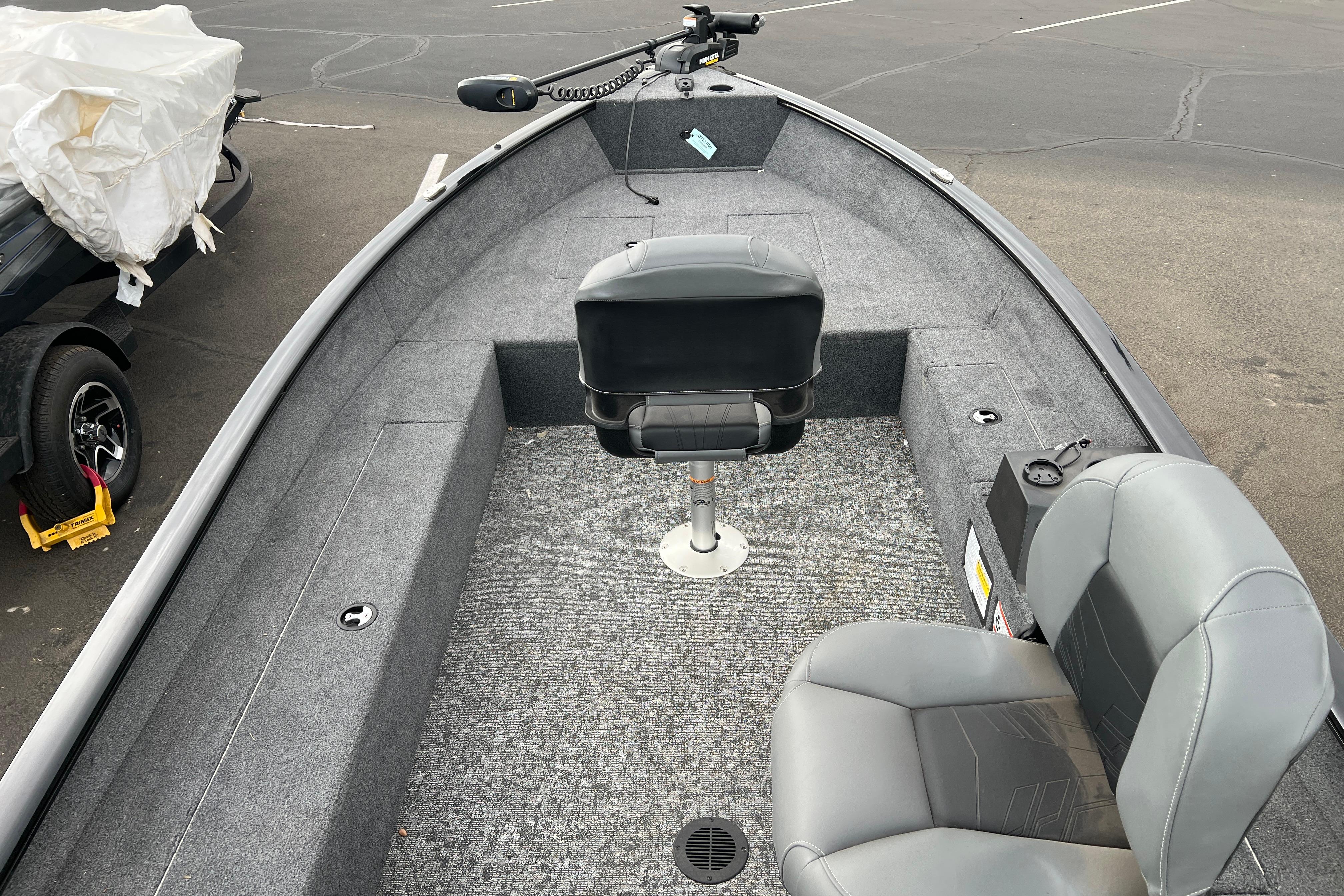 2025 Tracker Super Guide V-16 T boat interior with gray seating and carpeted deck.
