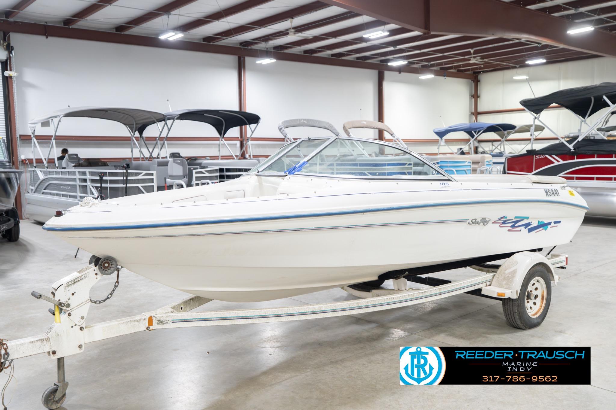 1995 Sea Ray 175 Bow Rider boat on trailer in indoor showroom.