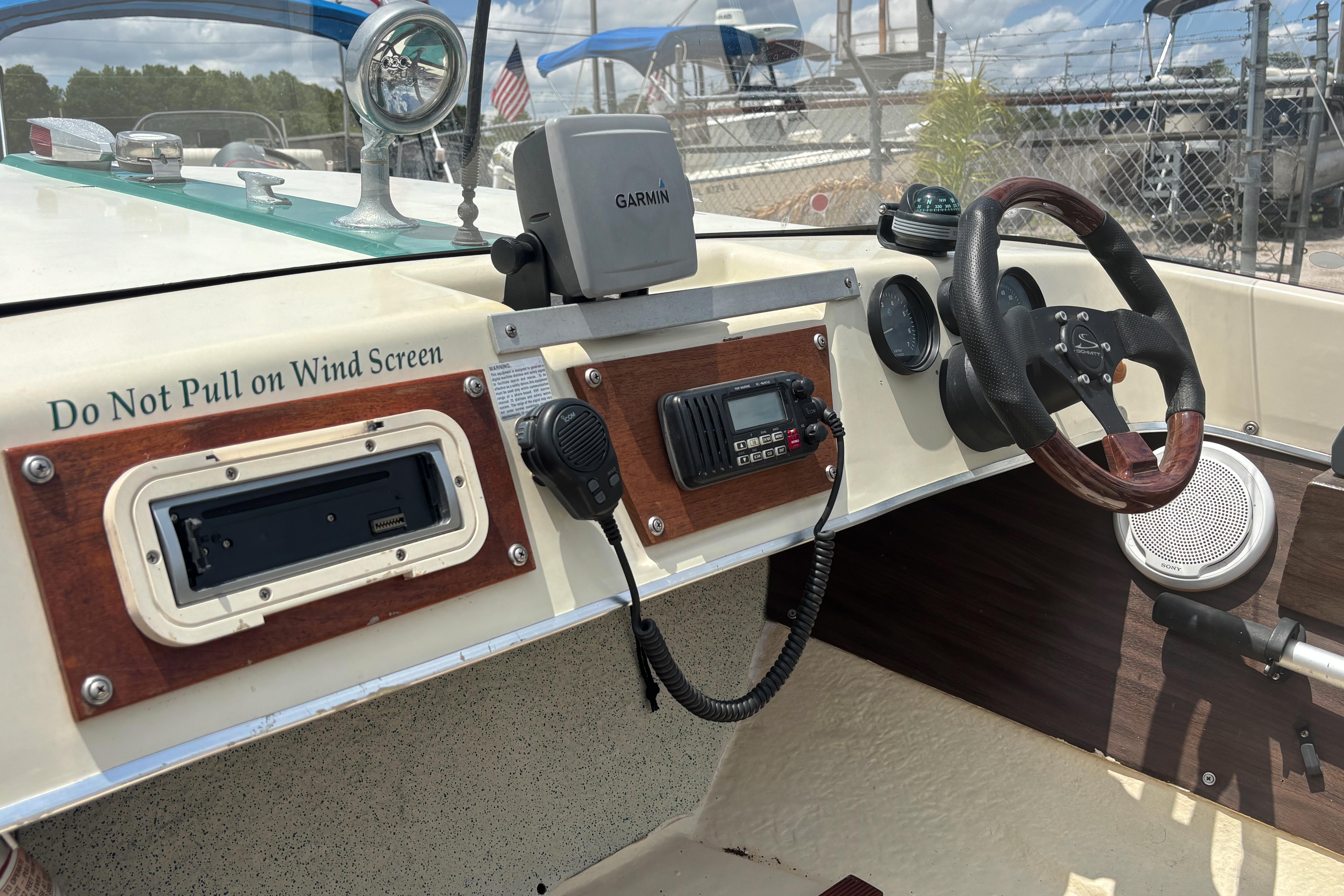 Interior of a 1966 Mohawk 15 boat with steering wheel and navigation equipment.