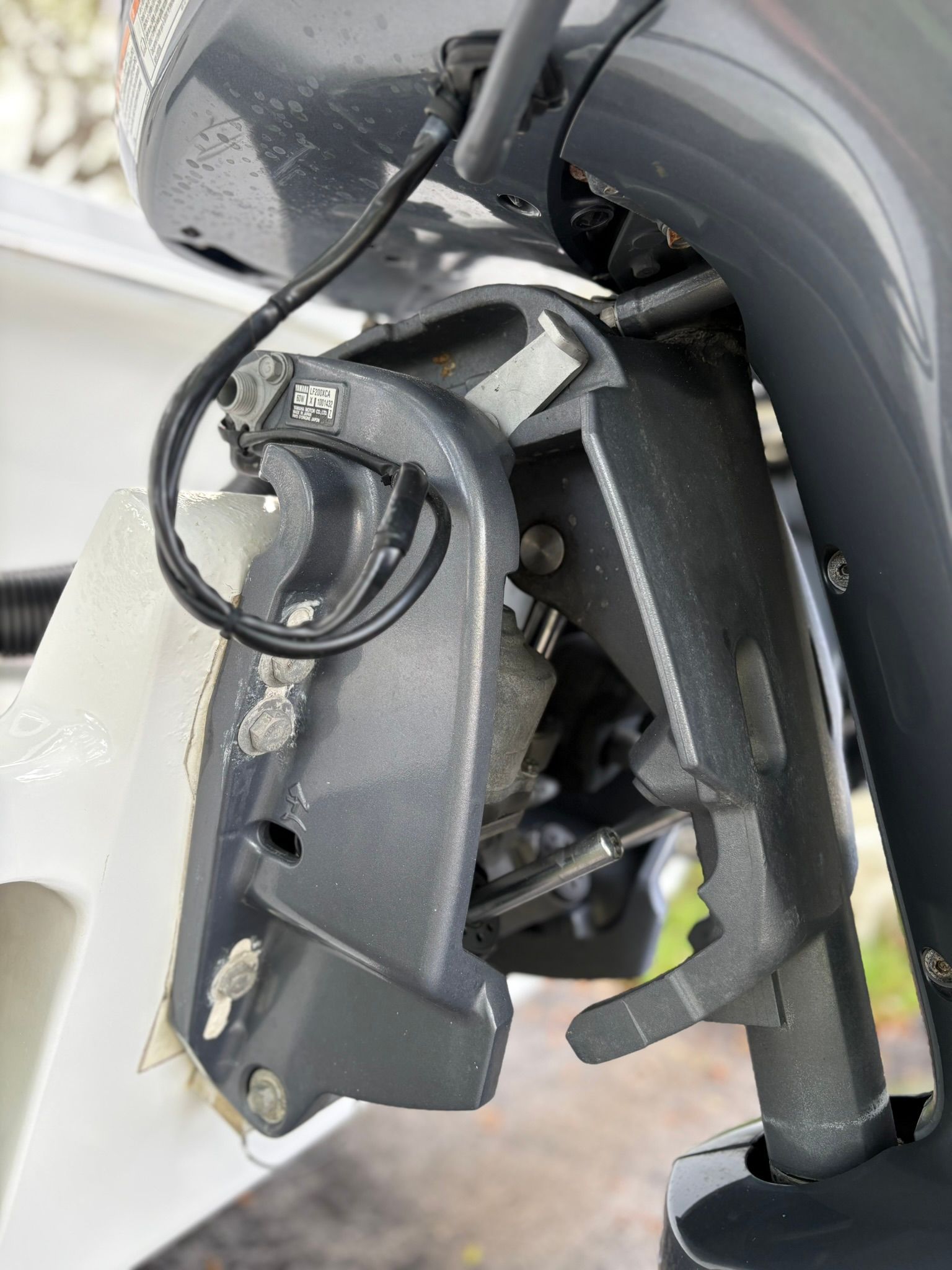 Close-up of a boat's outboard motor with visible cables and mechanics.