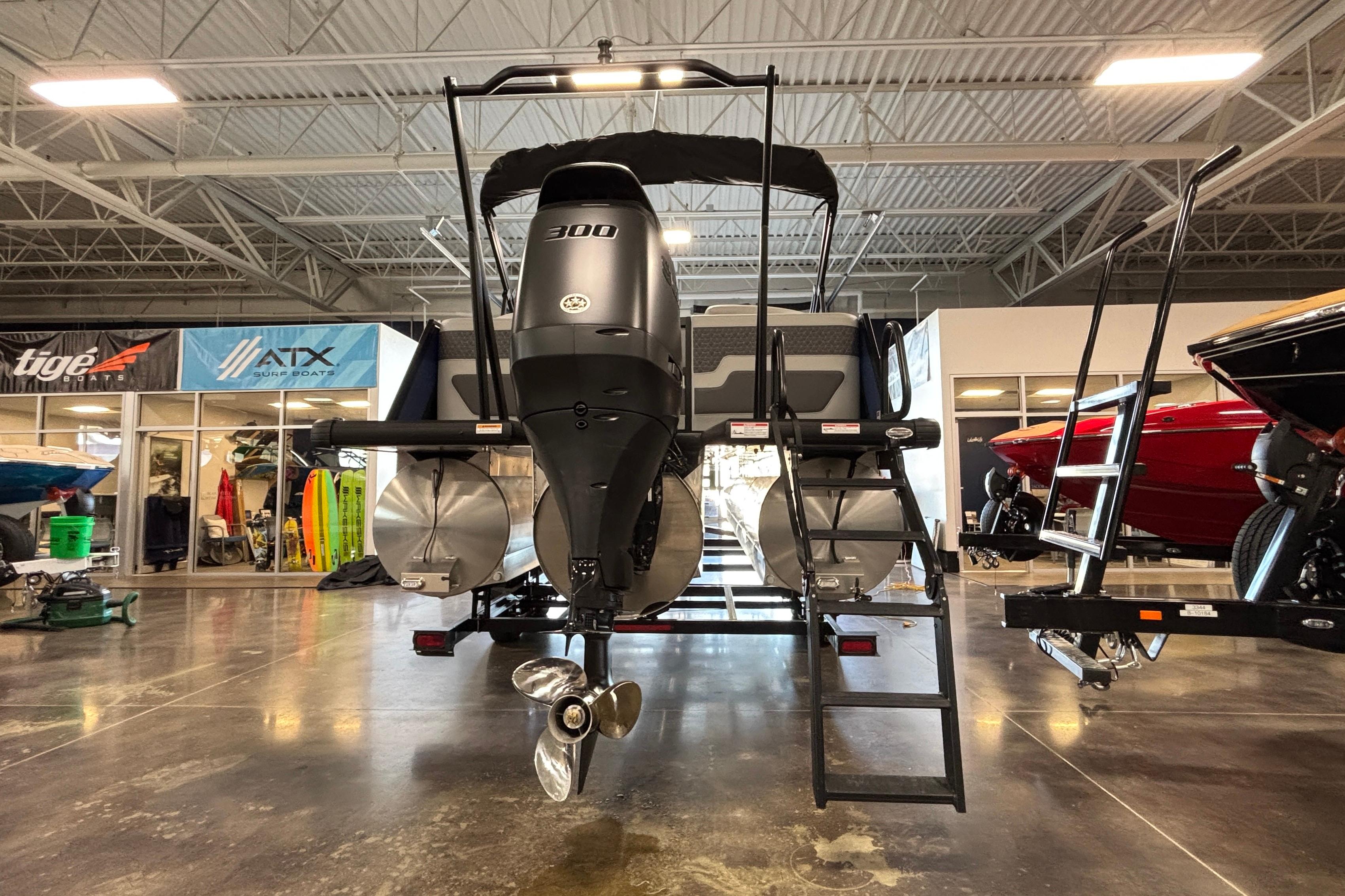 2026 Viaggio Z24U pontoon boat with powerful 300 HP engine in showroom.