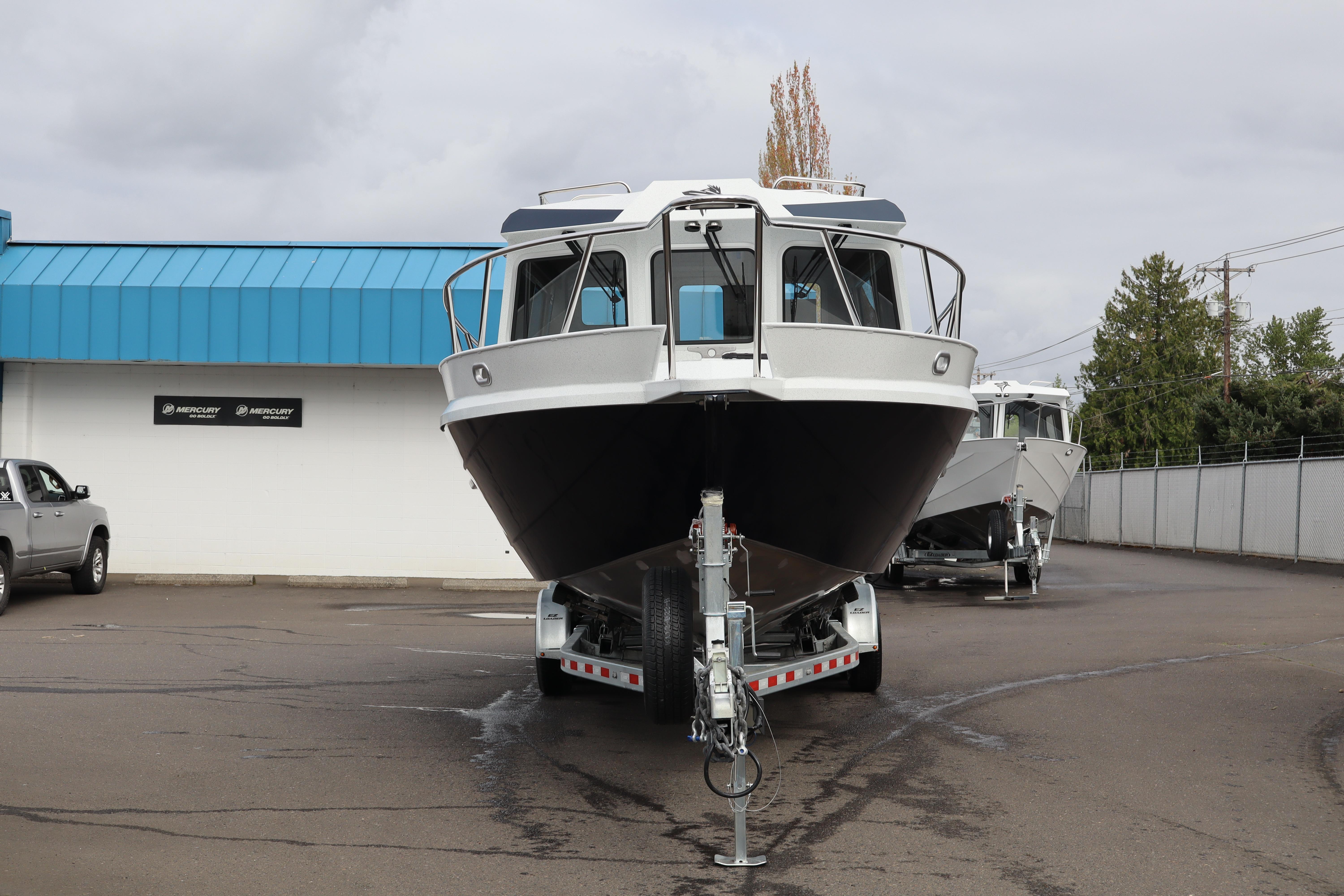 2026 KingFisher 3025 XRS boat on trailer, parked outside dealership.