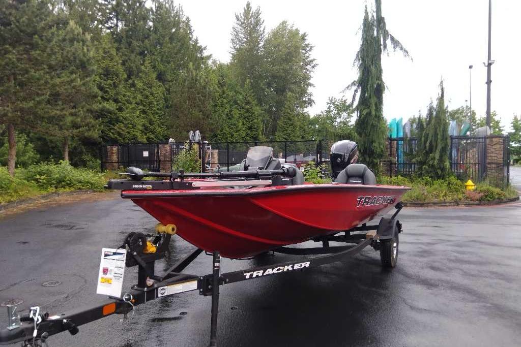 2026 Tracker Pro Team 175 boat on trailer in a wooded area.