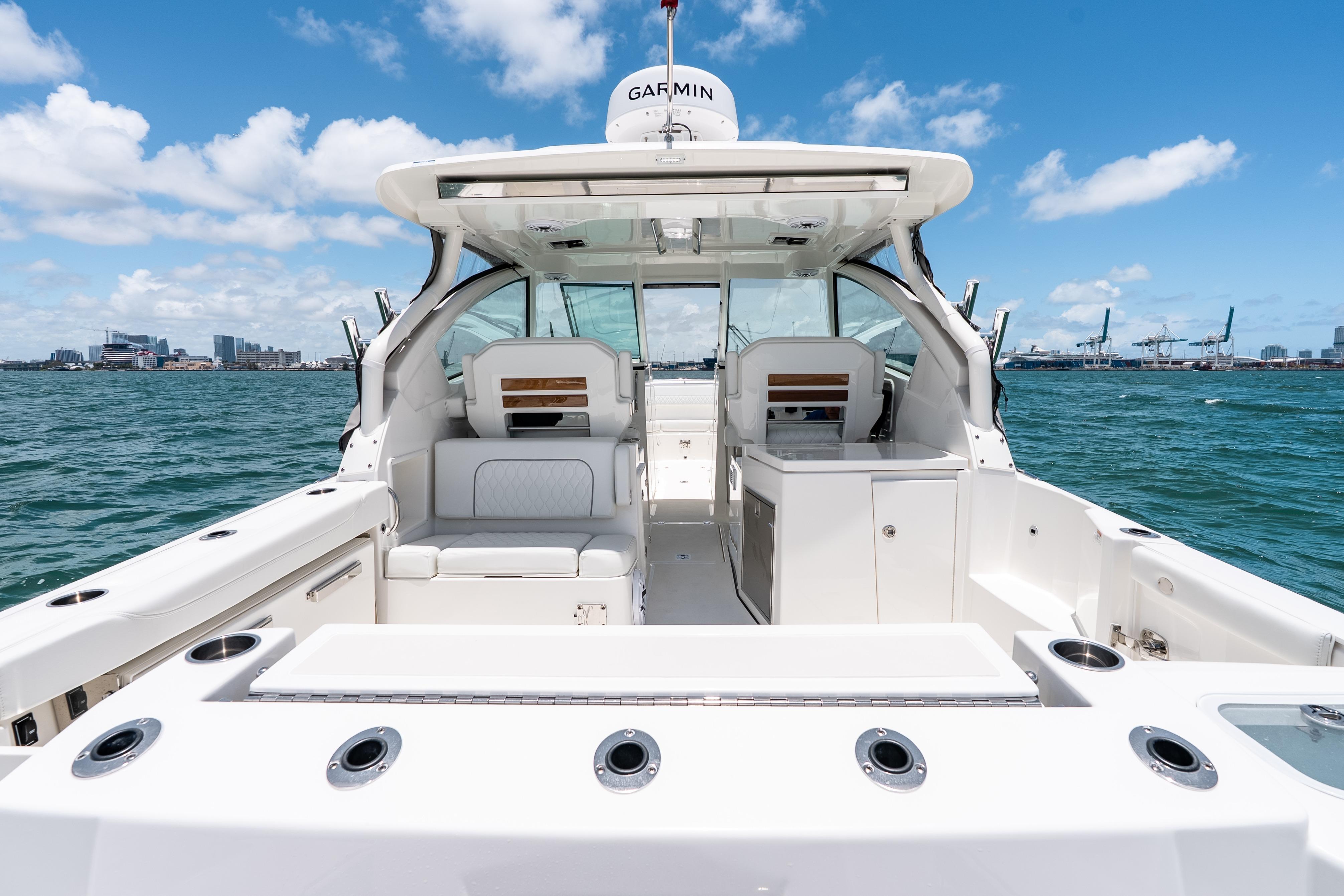 2026 Pursuit DC 326 Dual Console boat on water, featuring spacious seating and modern design.