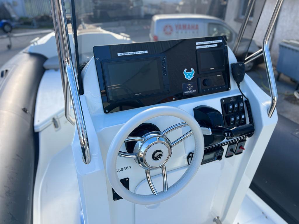 2023 Capelli Tempest 700 boat dashboard with steering wheel and control panel.