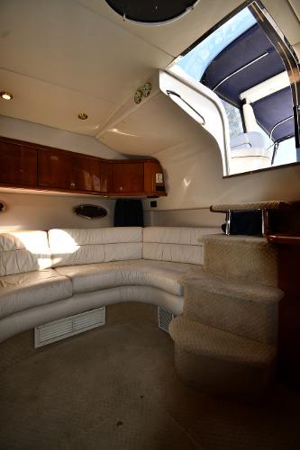 Interior of 1997 Sunseeker Camargue 47 yacht with white seating and skylight.