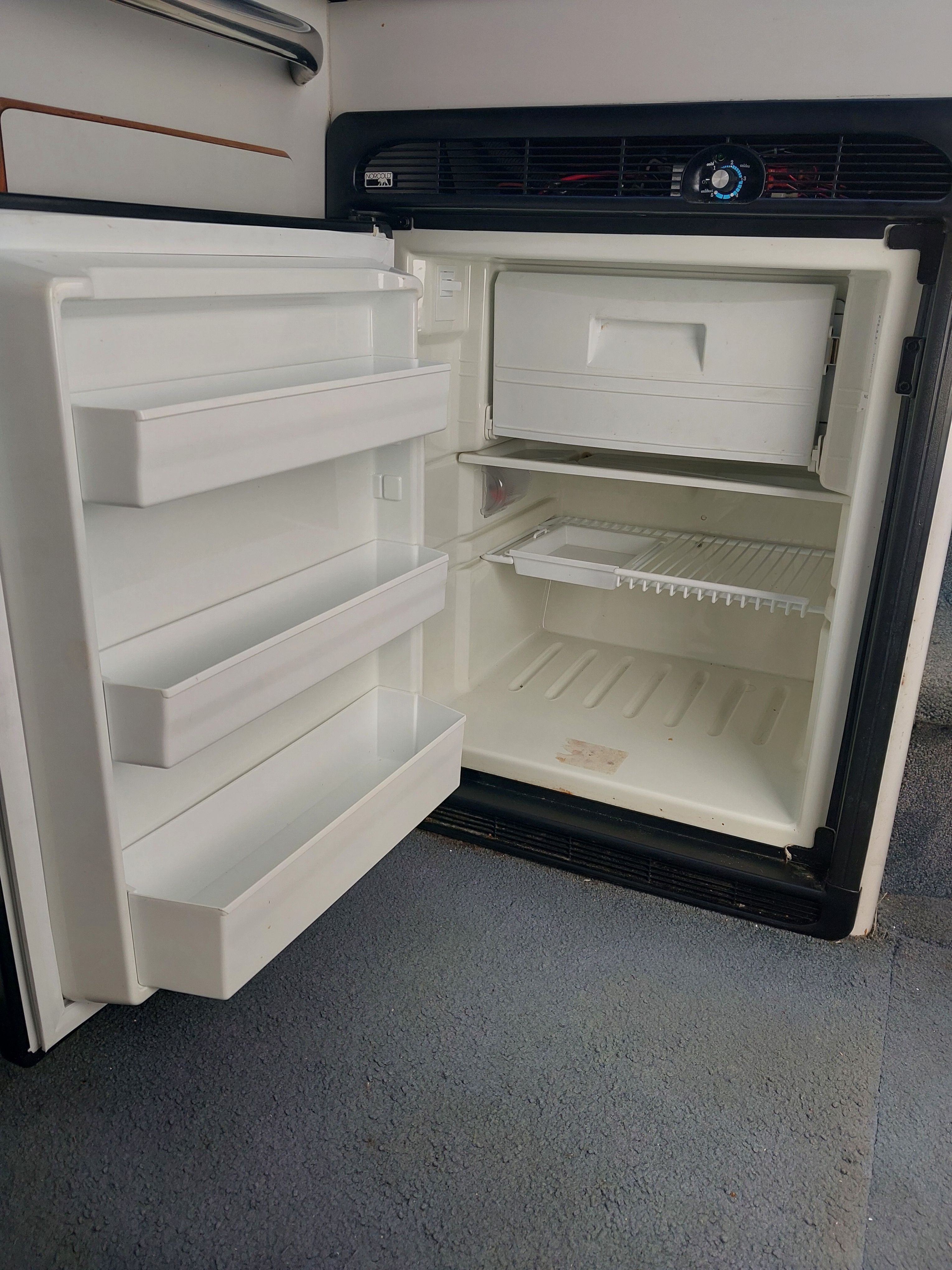 Open refrigerator on a 1991 Sea Ray 370 Sedan Bridge yacht.