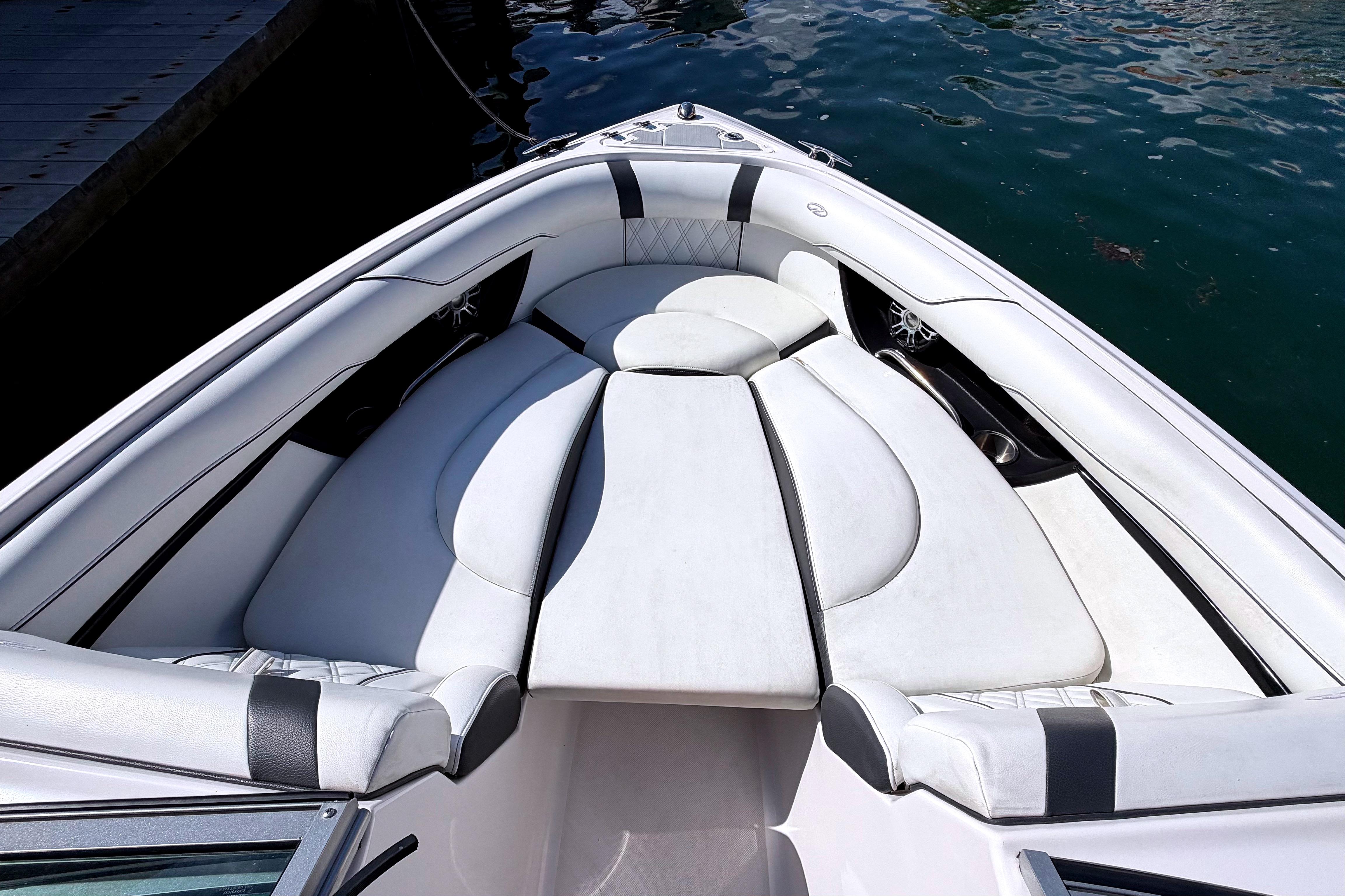 2020 Regal 2300 Bowrider boat interior with white cushioned seating, docked on water.